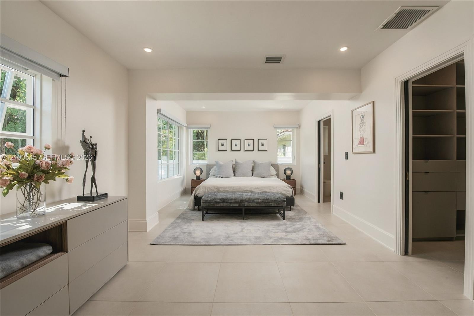 Sunlit Primary Bedroom with direct pool access.