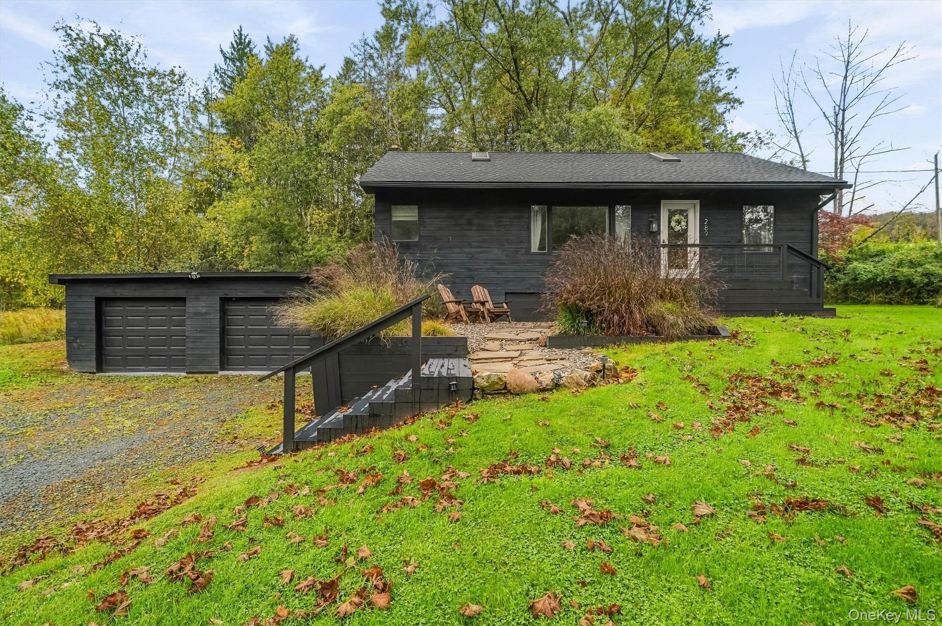 2 car garage, steps to gravel/bluestone entrance, cozy courtyard
