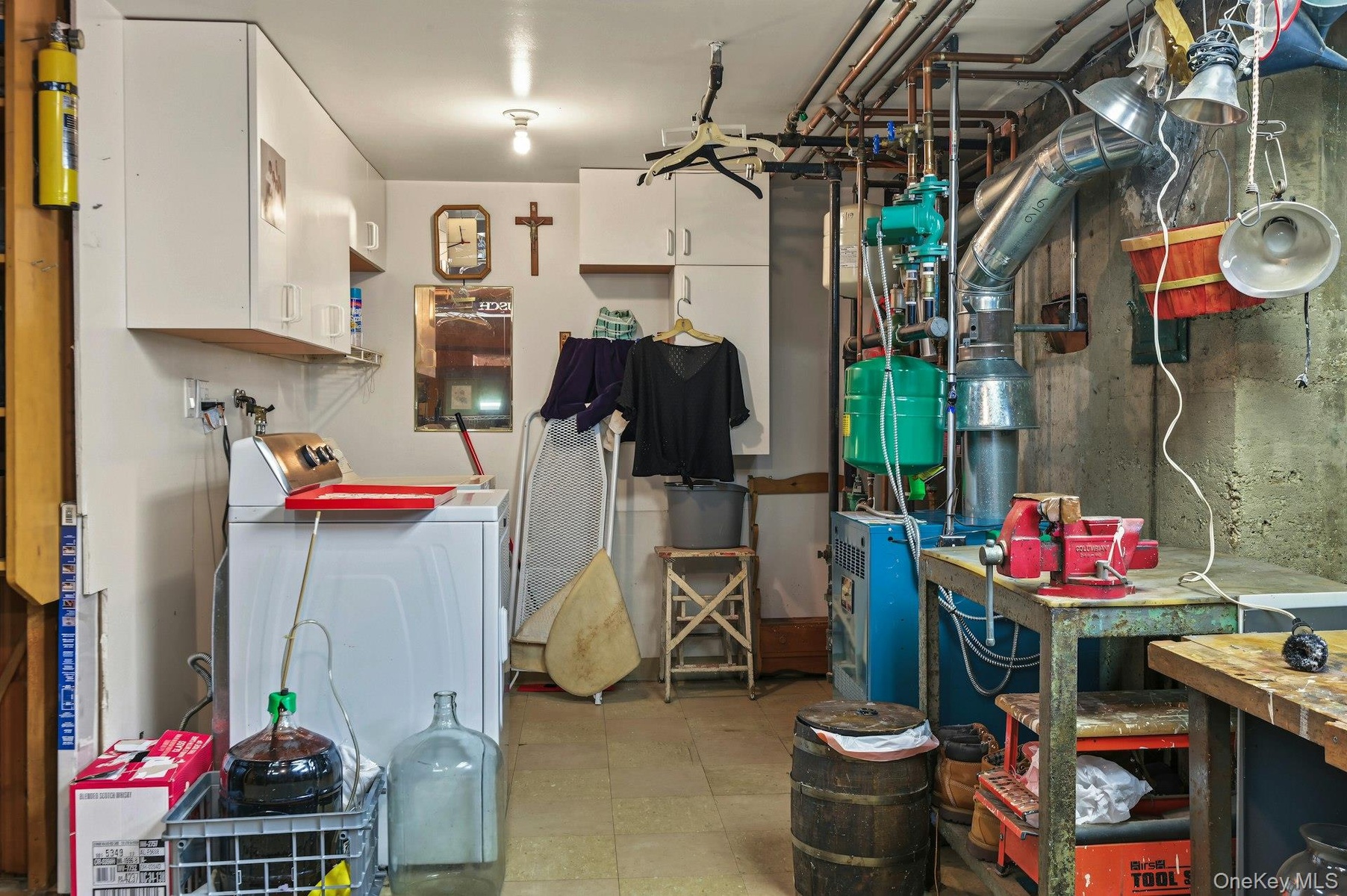 Laundry/storage room in unfinished portion of basement offering plenty of additional flexible space.