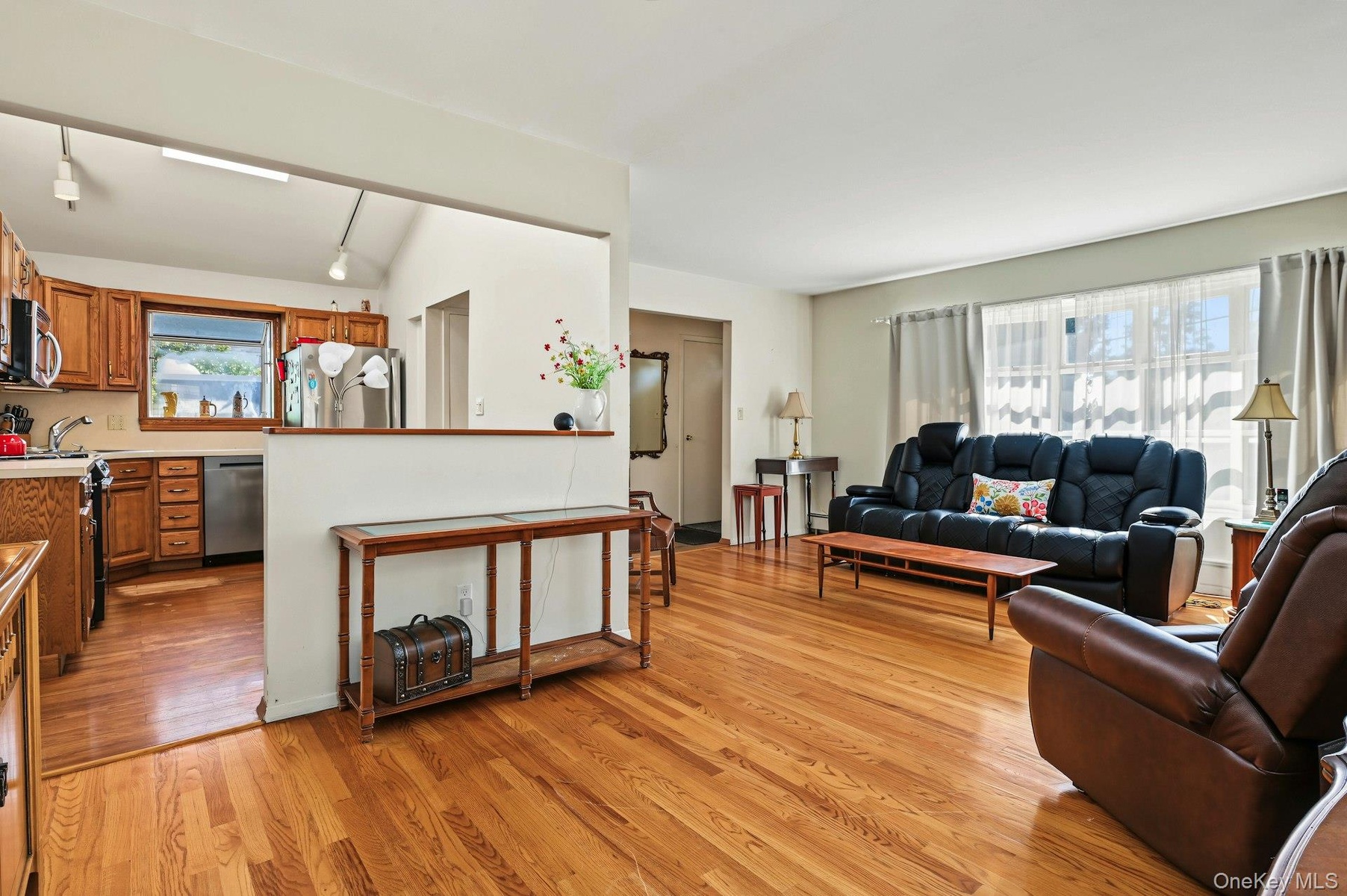 Formal dining room with hardwood floors and an easy flow into the kitchen and living room.