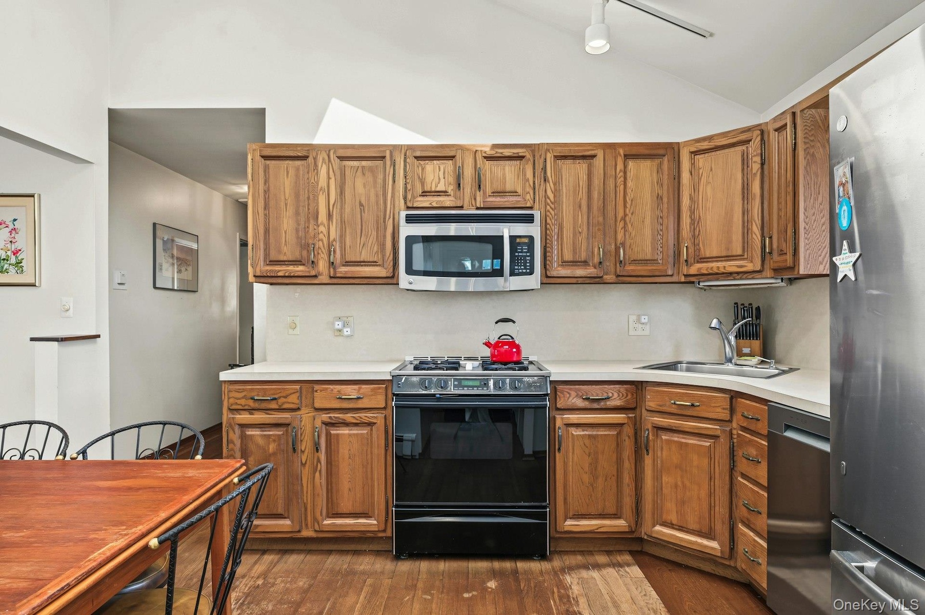 Bright eat-in kitchen with vaulted ceiling &  skylight