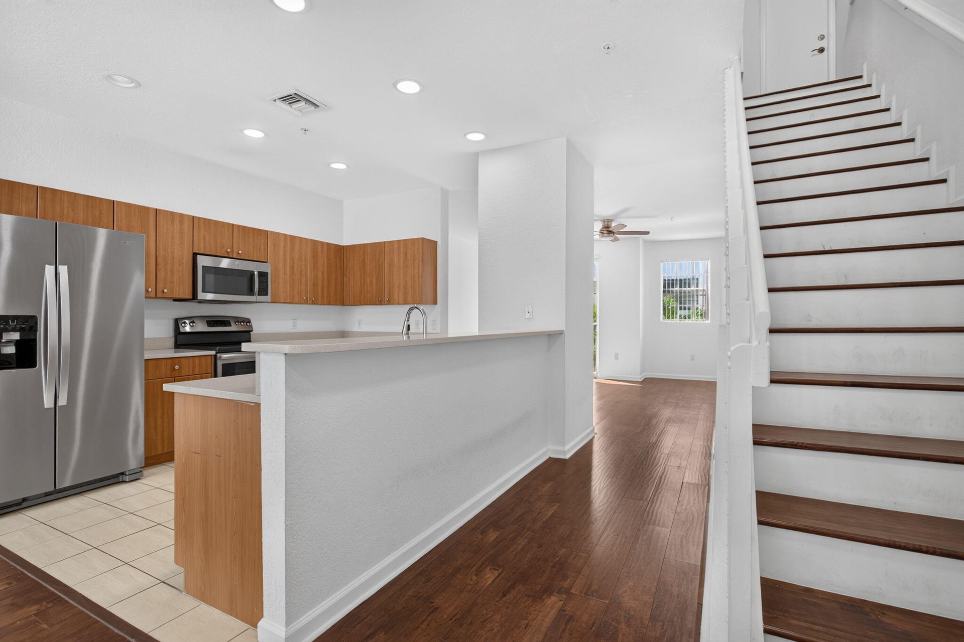 Kitchen featuring stainless steel appliances, wood-finish cabinetry, and recessed lighting