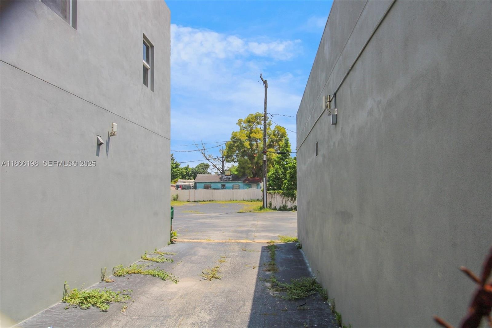 Drive between the two adjacent stand along buildings to access the large guest parking area.