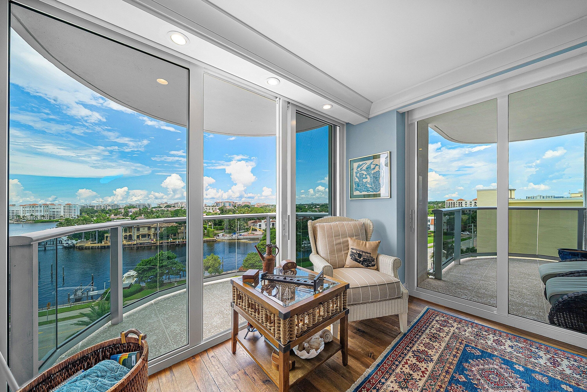 Expansive water scenery, floor-to-ceiling glass doors, recessed lighting, wood-finish flooring, and crown molding