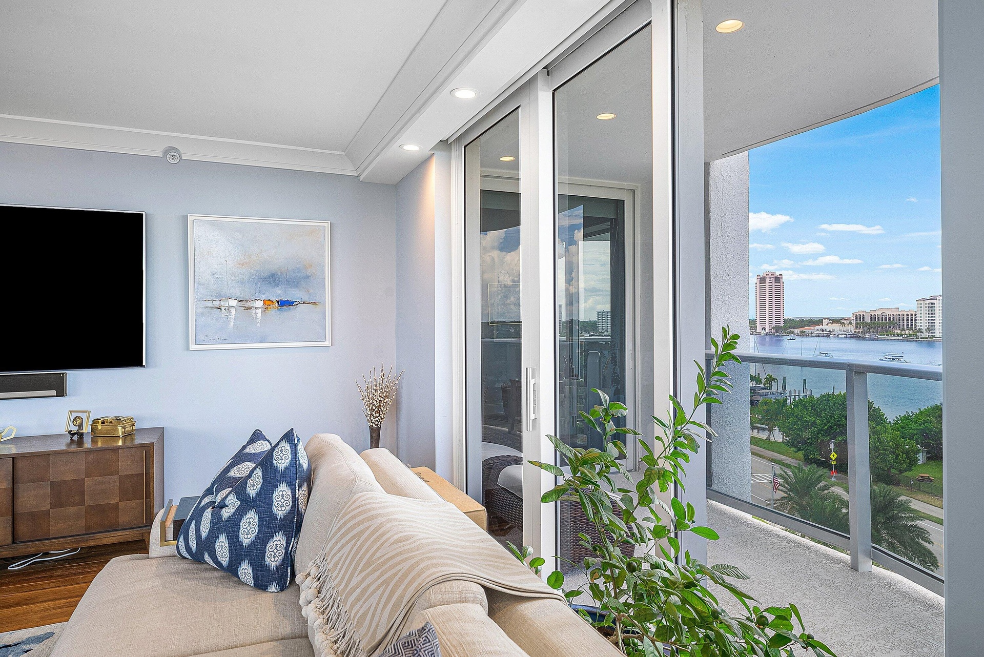 Sliding glass doors opening to a balcony with glass railings