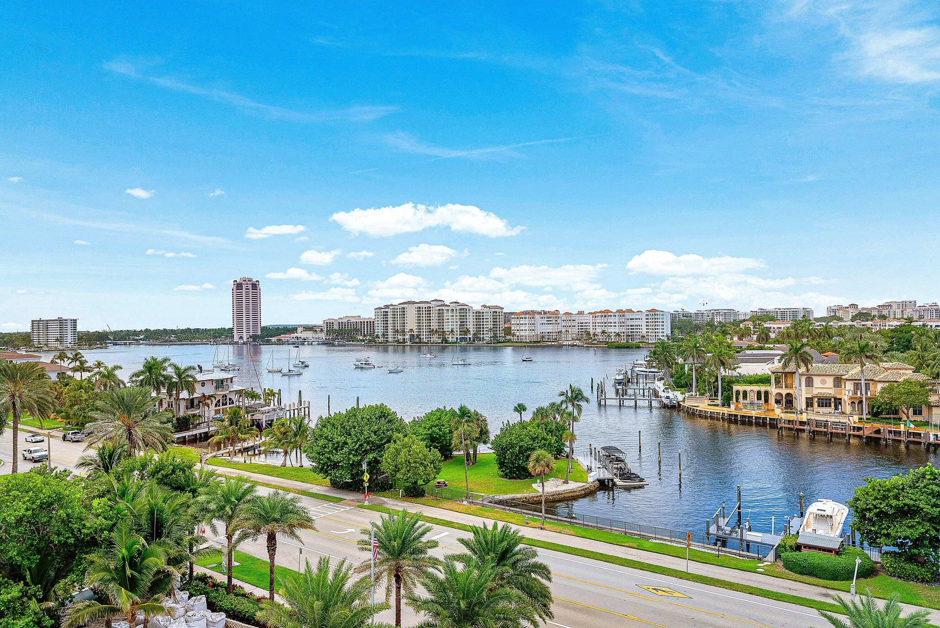 Waterfront setting with multiple docks and established palm trees
