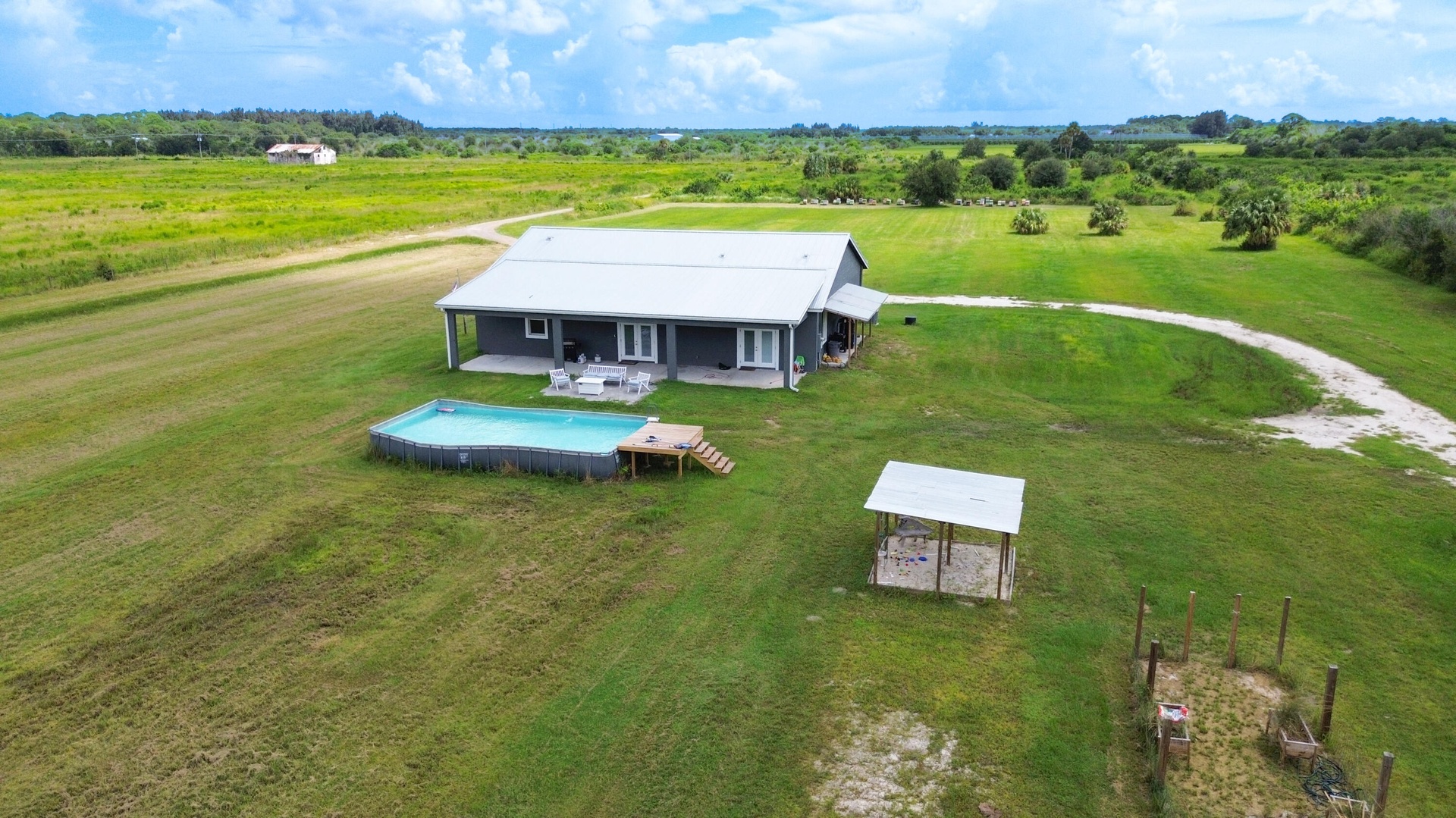 Aerial of the home with pool and guest unit