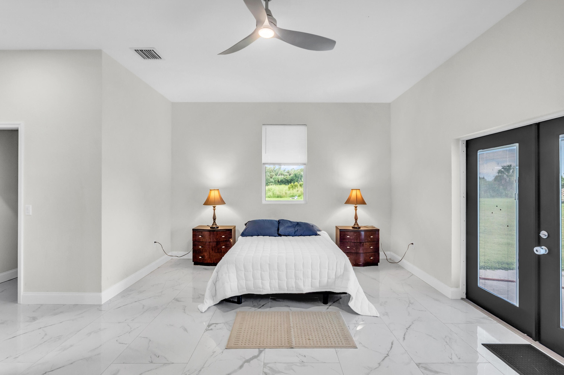 Primary suite with ceiling fan and French doors