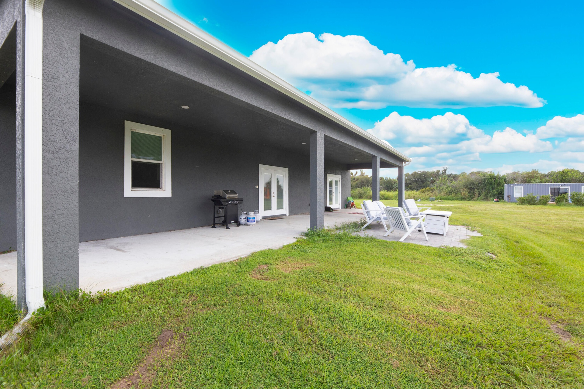 Covered porch overlooking the open acreage