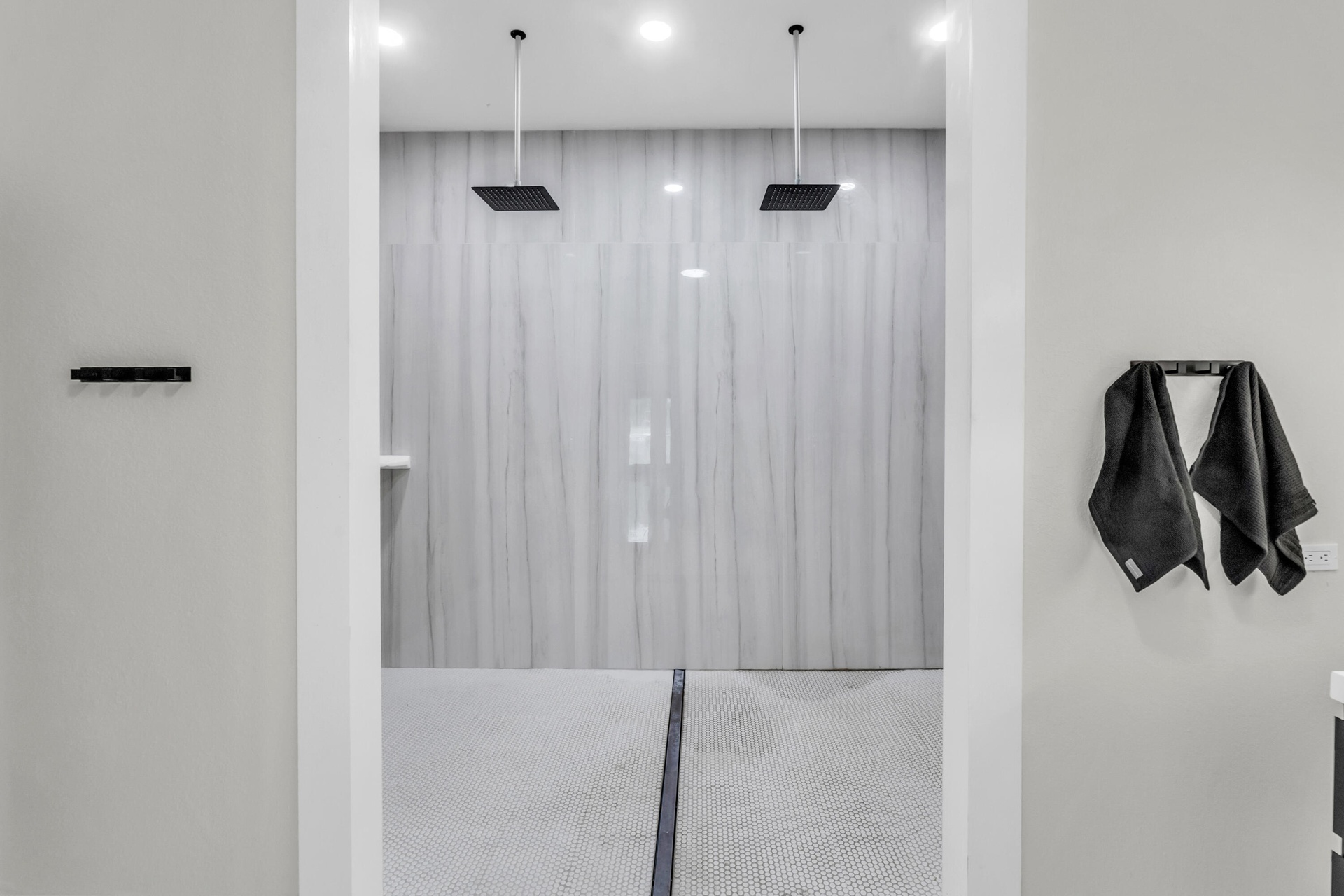 Oversized walk-in shower with dual rain showerheads