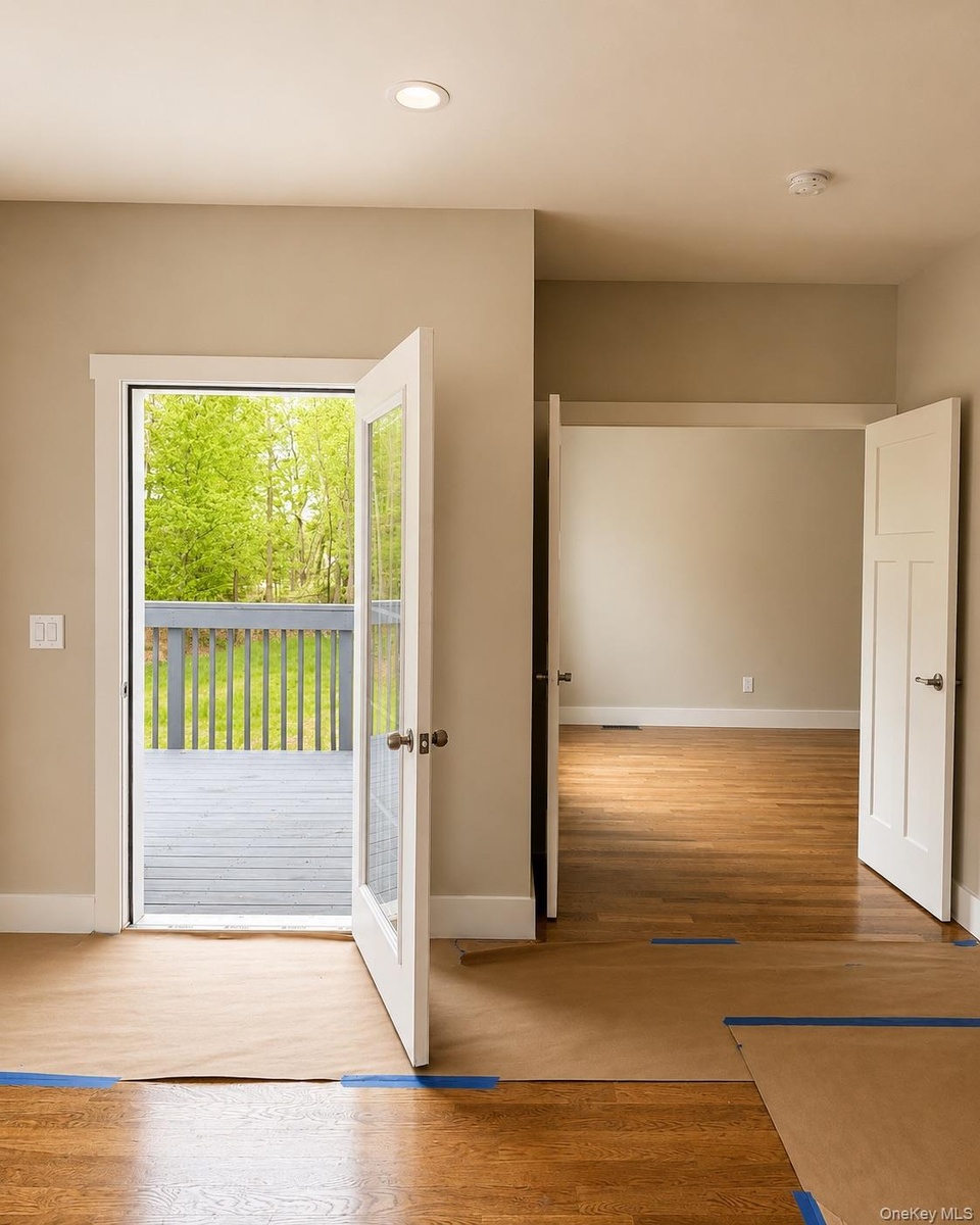View from the living room of the walk-out deck and office, sitting or main level bedroom.