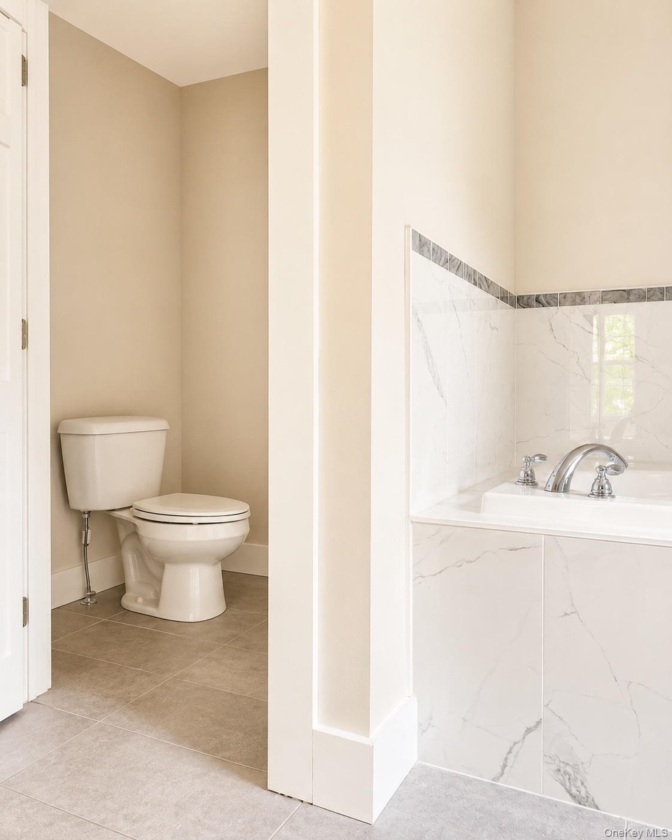 Separate water closet featuring a standard toilet