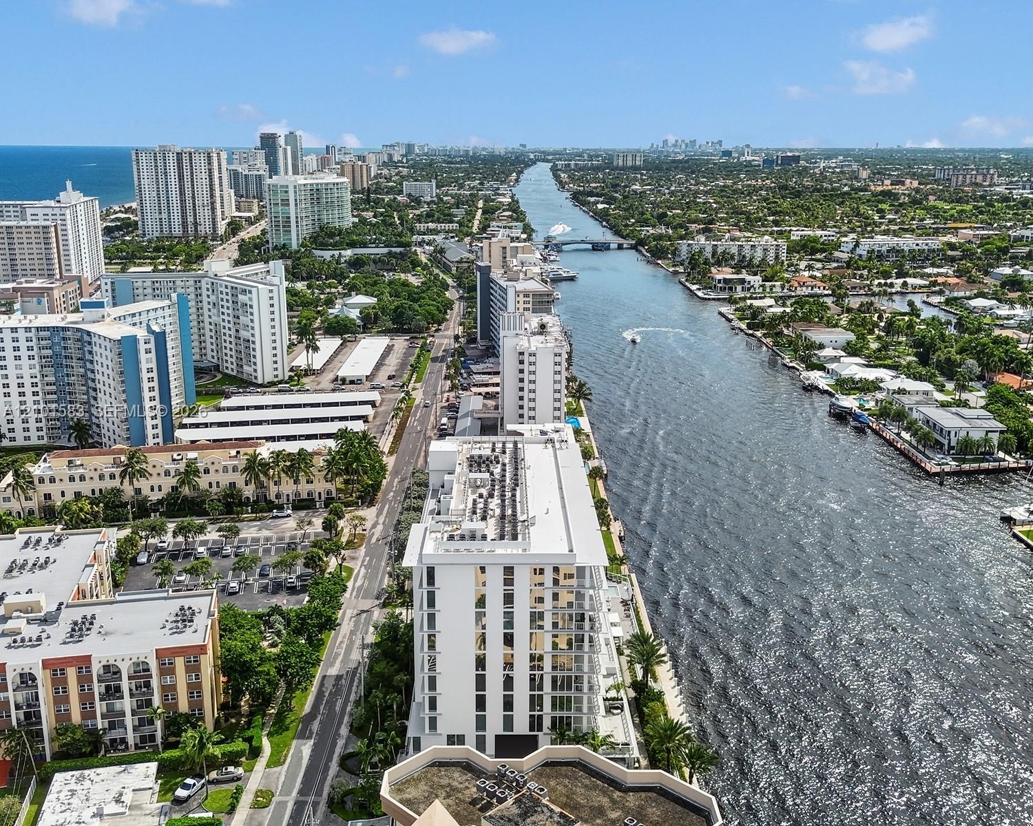 Aerial perspective of coastal landscape featuring deep-water waterway access, proximity to oceanfront high-rises, and established waterfront urban inf