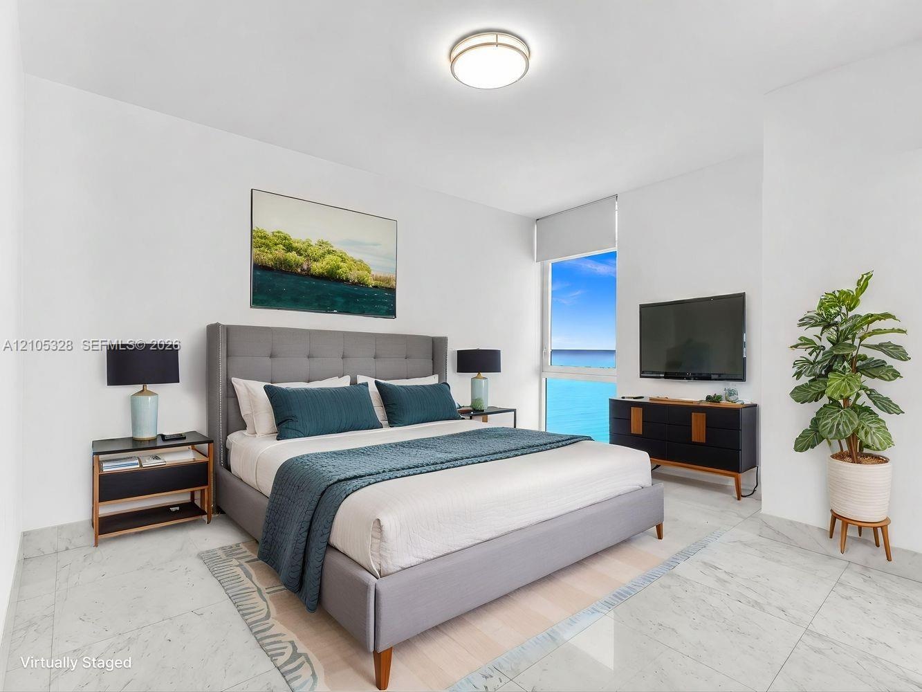 Bright and airy interior featuring soaring ceilings, dramatic floor-to-ceiling windows that fill the space with natural light, elegant hard-surface fl