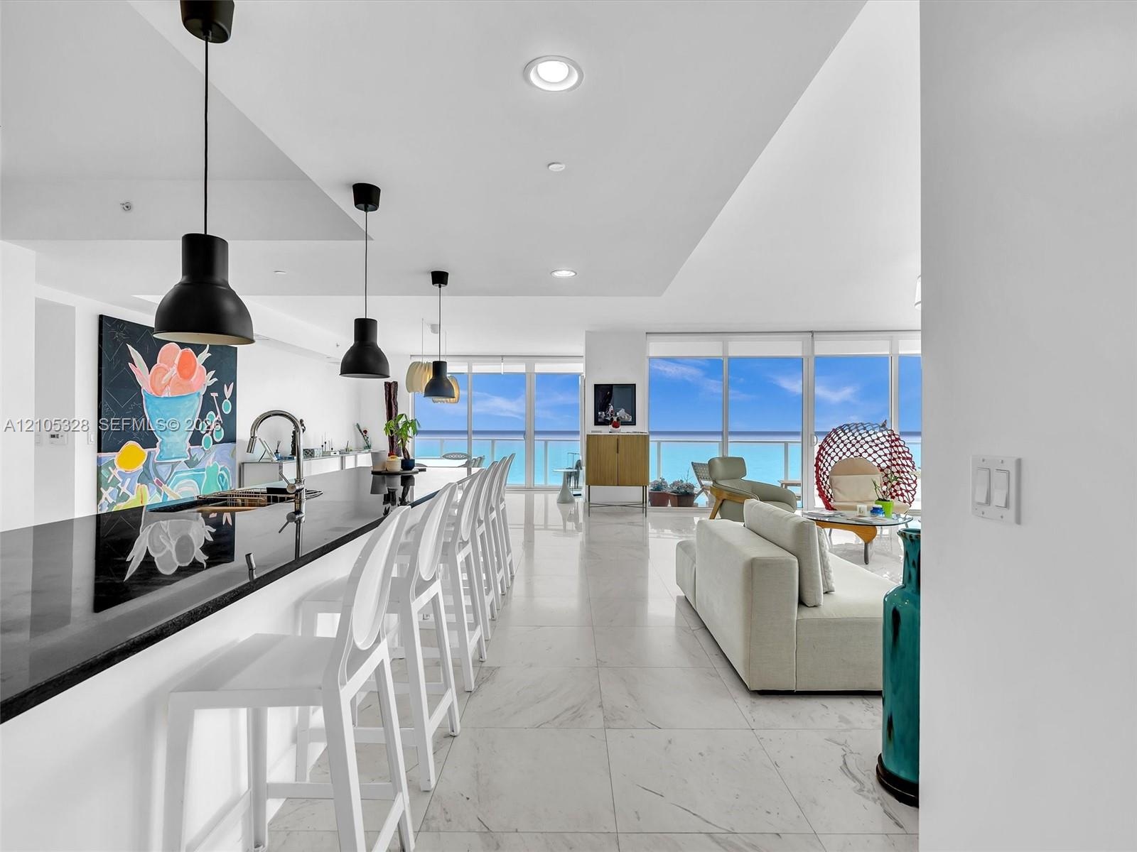 Expansive living area featuring elegant large-format marble-look tile flooring.