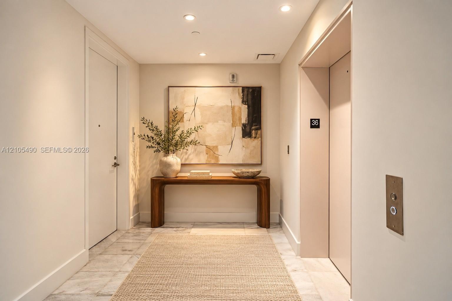 Foyer featuring stone tile flooring, recessed ceiling lighting, and a dedicated elevator access point
