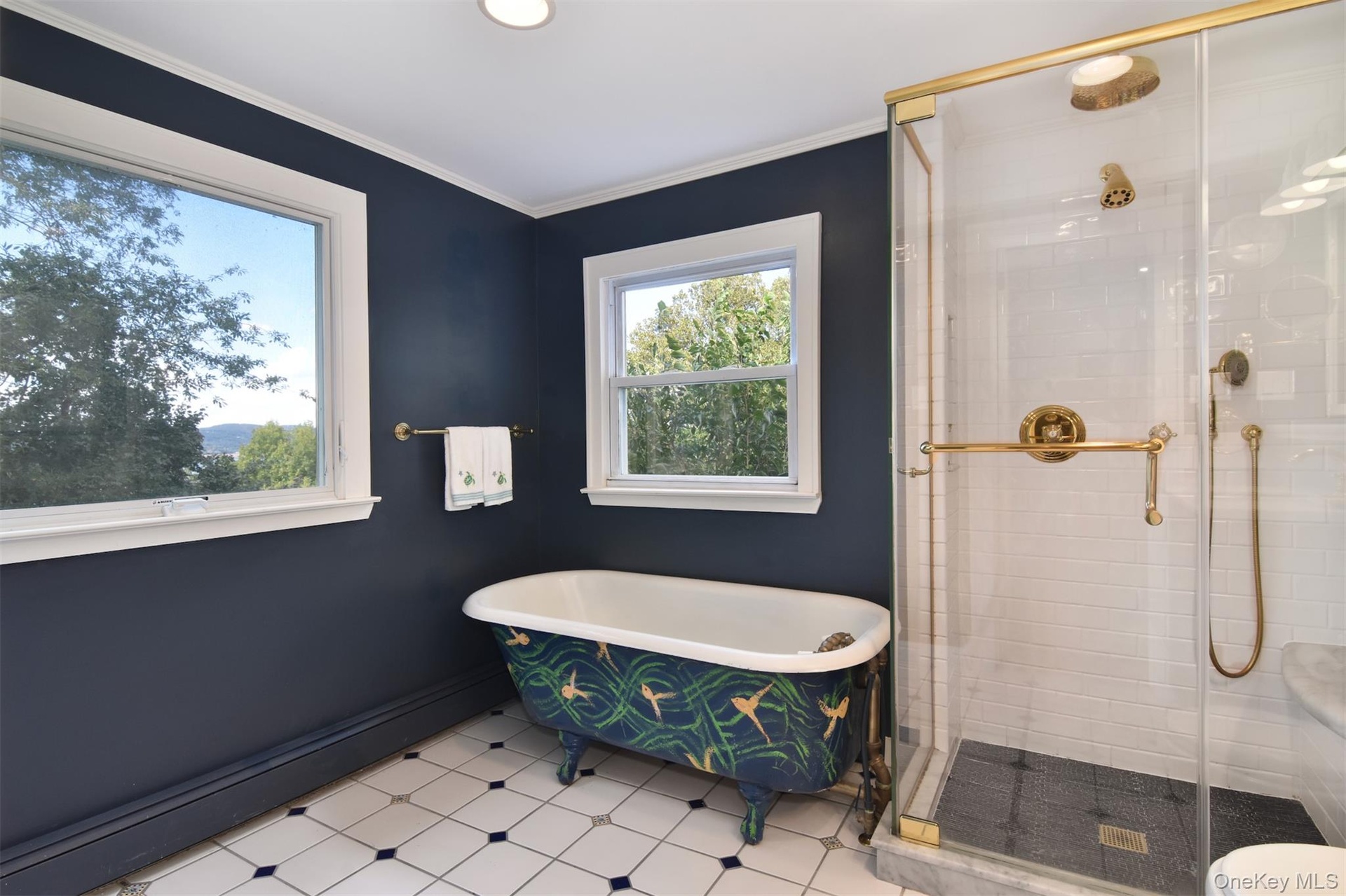 Picture windwow over the decoratively painted. Claw-foot soaking tub.