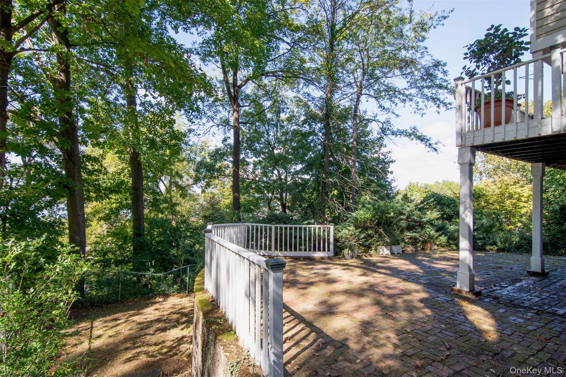 View of patio and porch above.