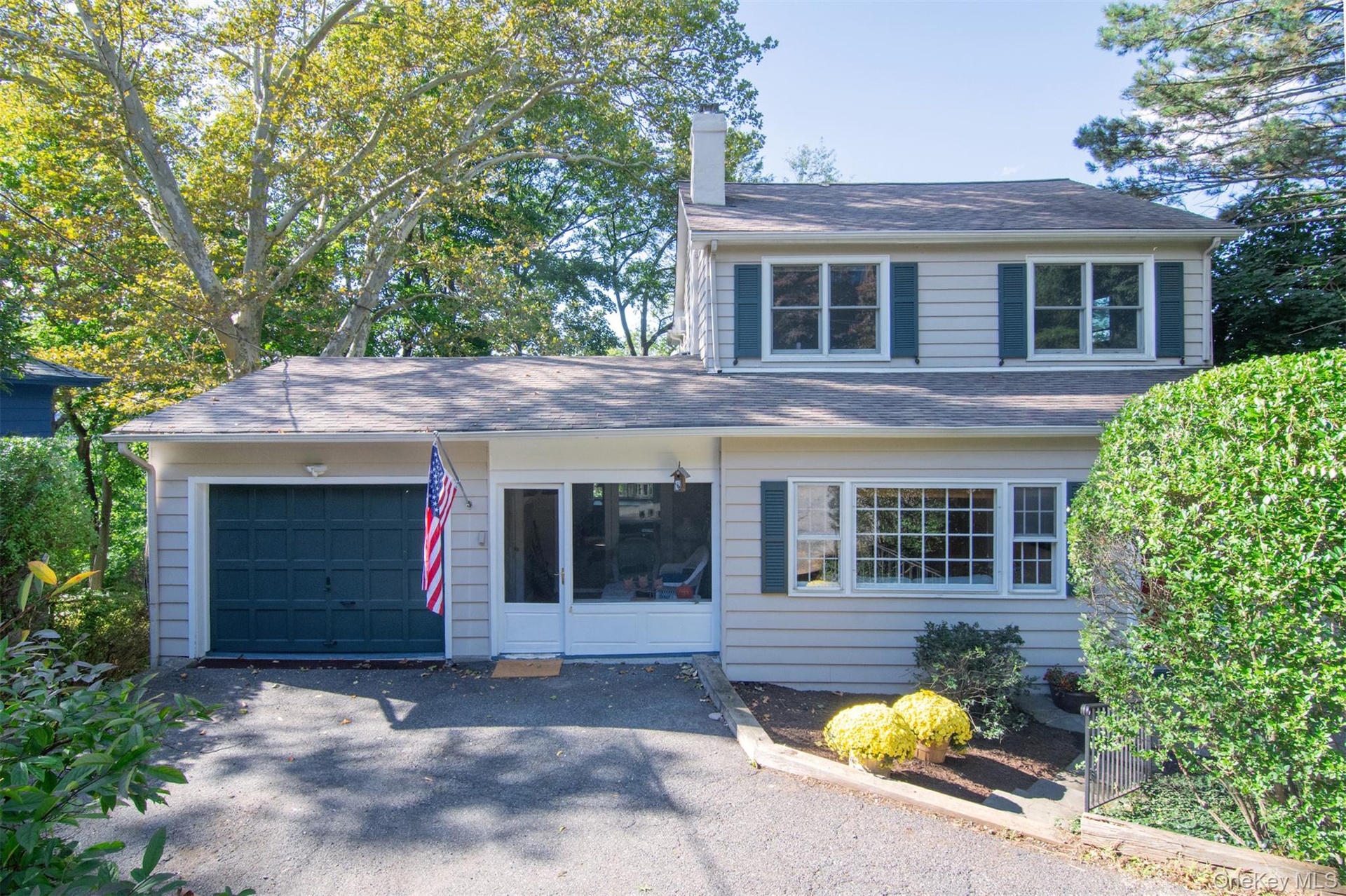One car garage and sun room entrance.