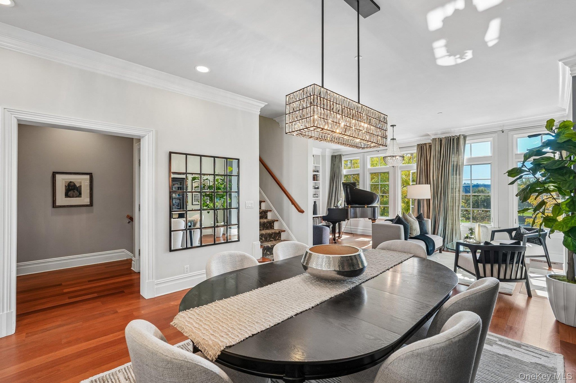 Santos Mahogany floors and crown molding  run throughout the open concept layout
