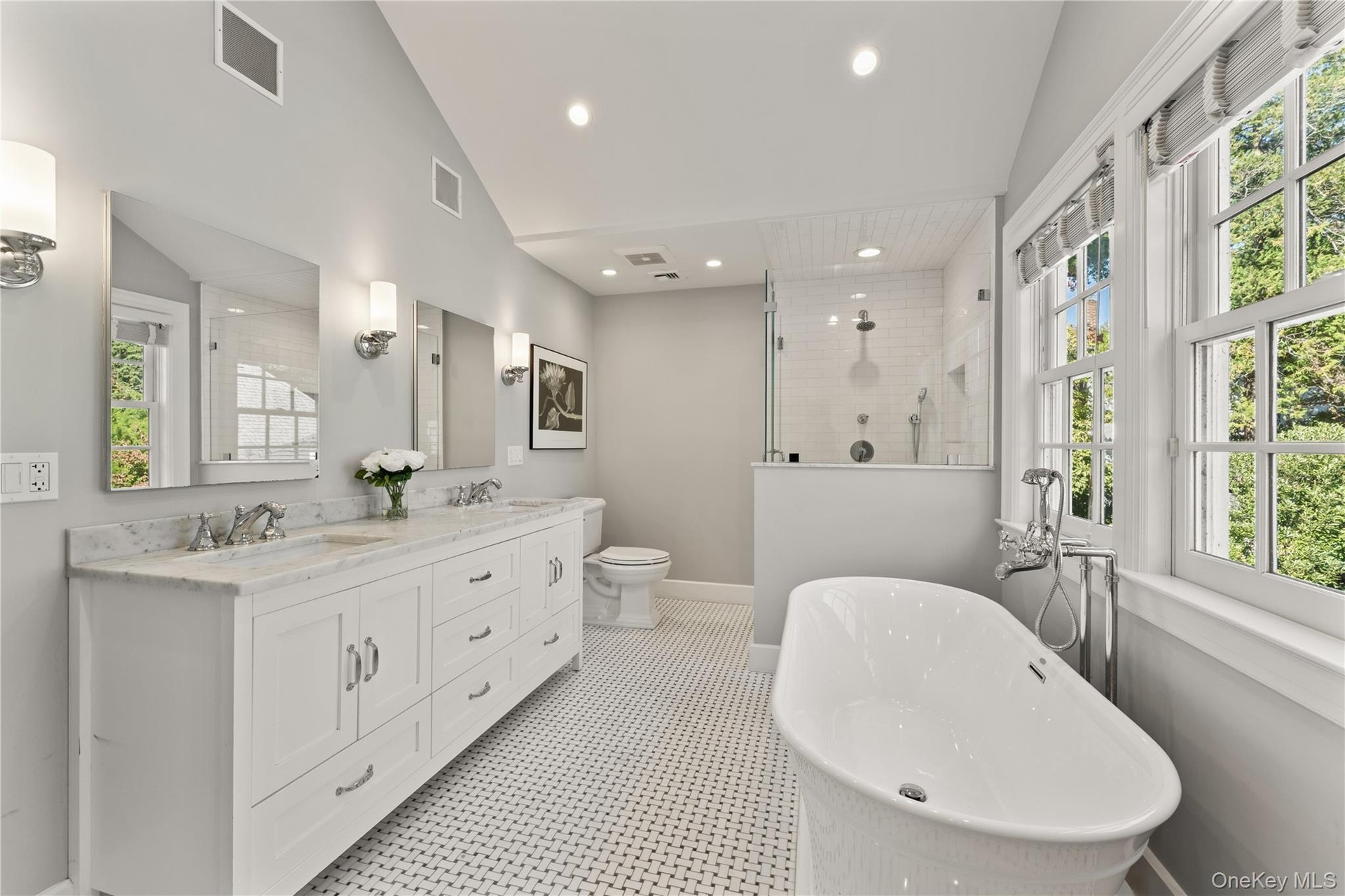 Spa-like primary bathroom with radiant heated floors, soaking tub, double vanities and shower