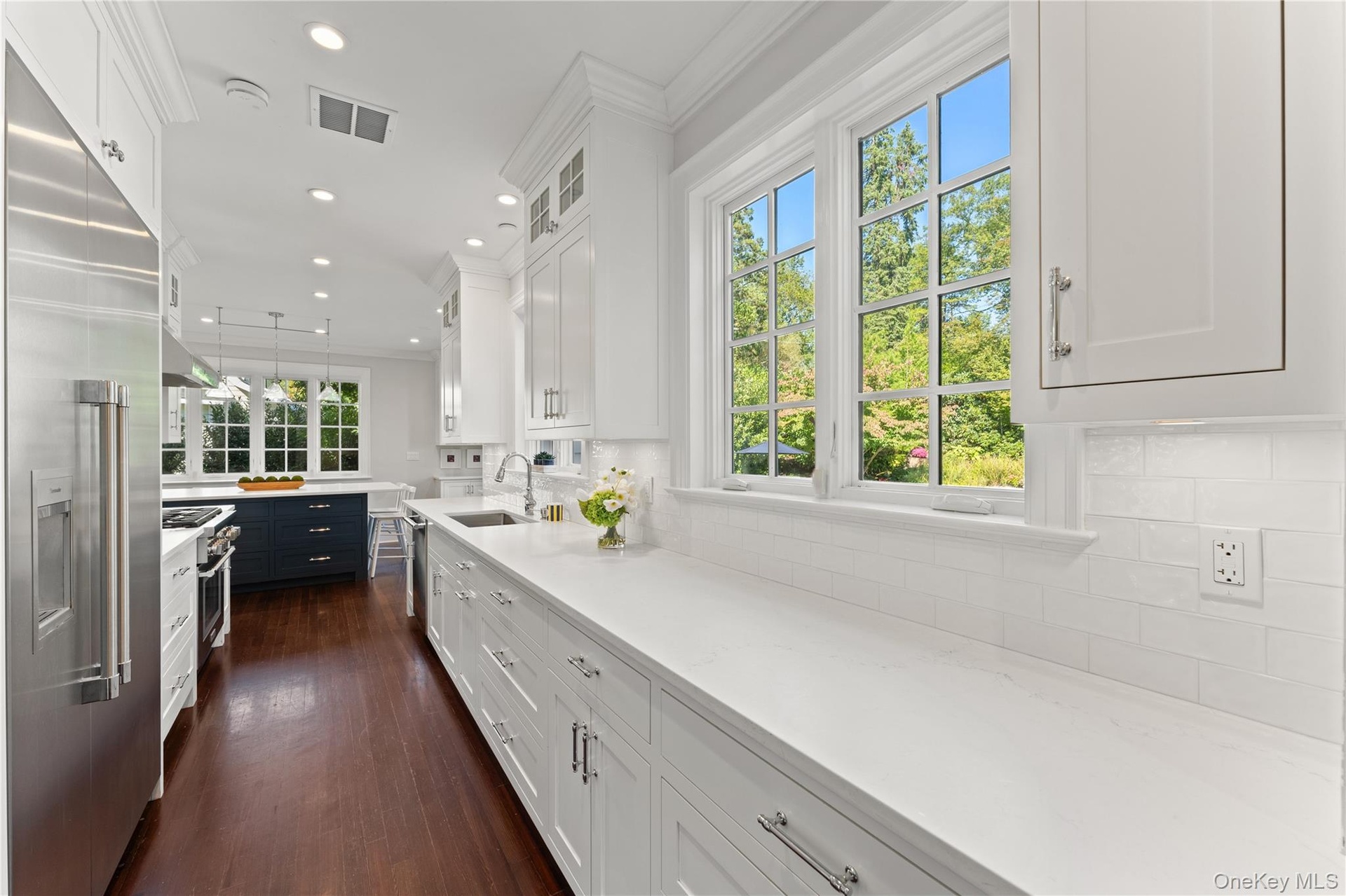 Sunlit and spacious updated kitchen with extensive counter space and custom cabinetry