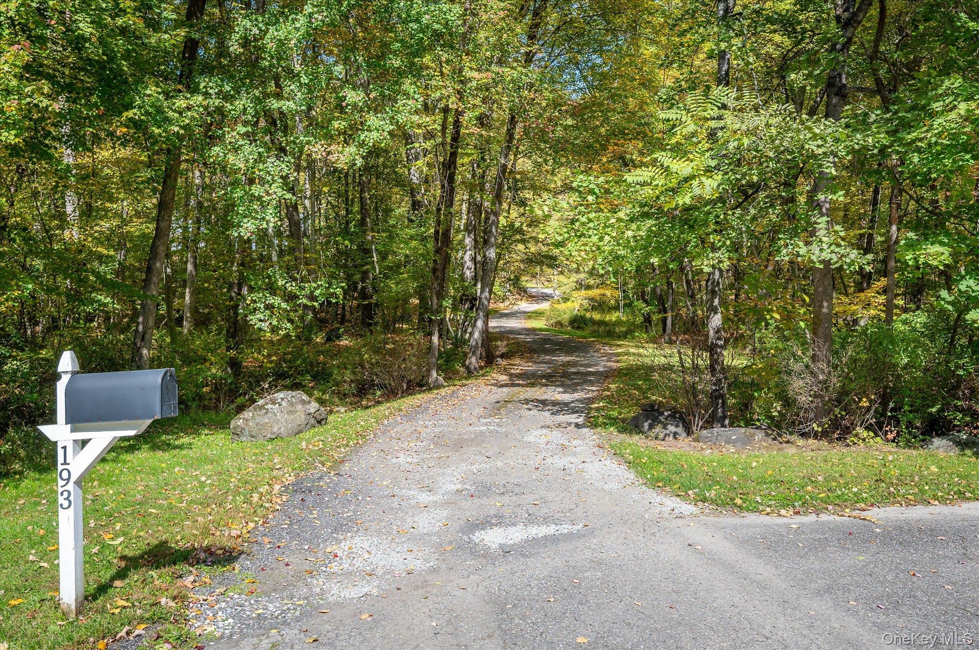 Meandering driveway leads to house with ample parking