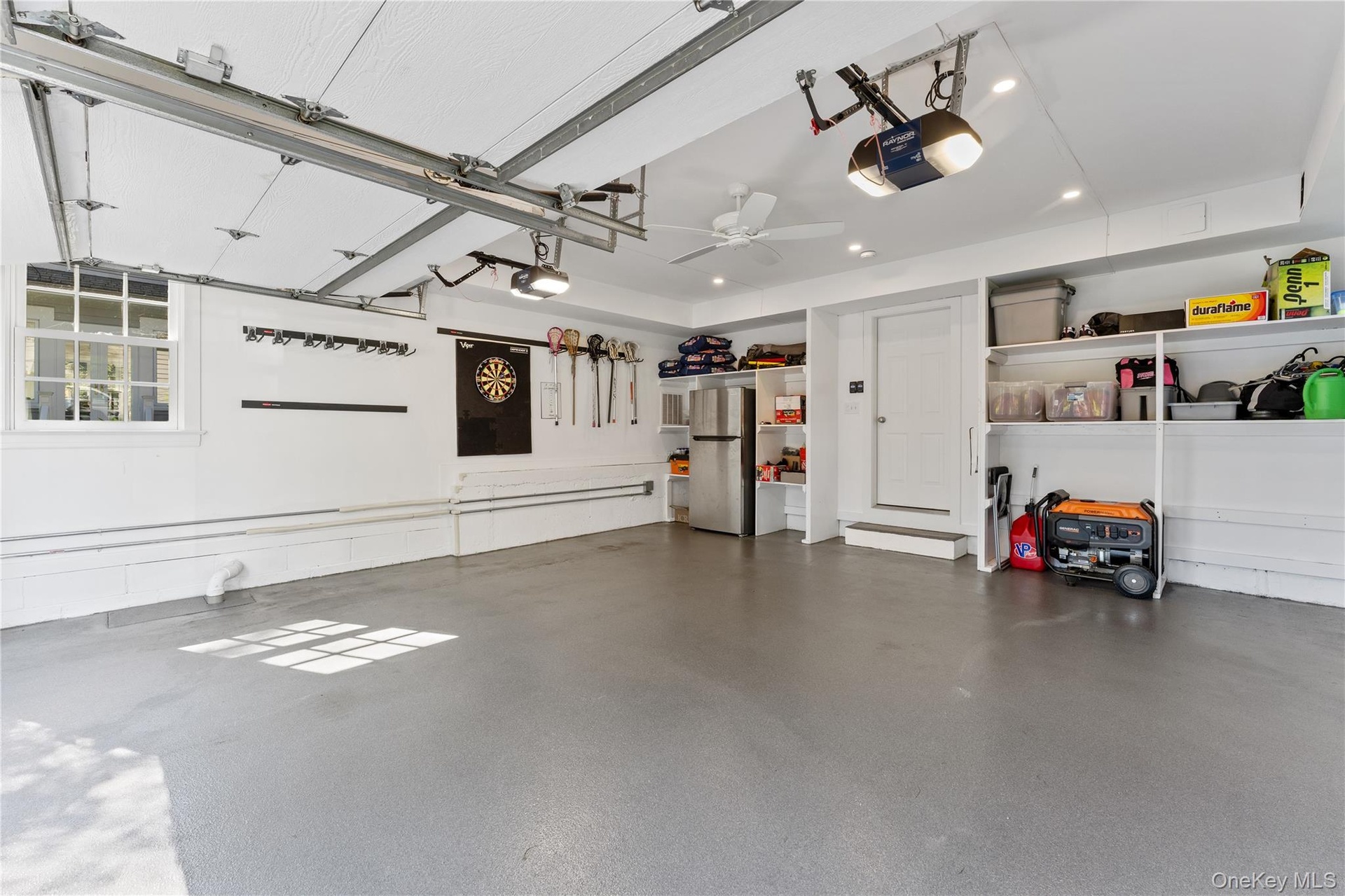 Two-car garage with shelving and storage space for organization