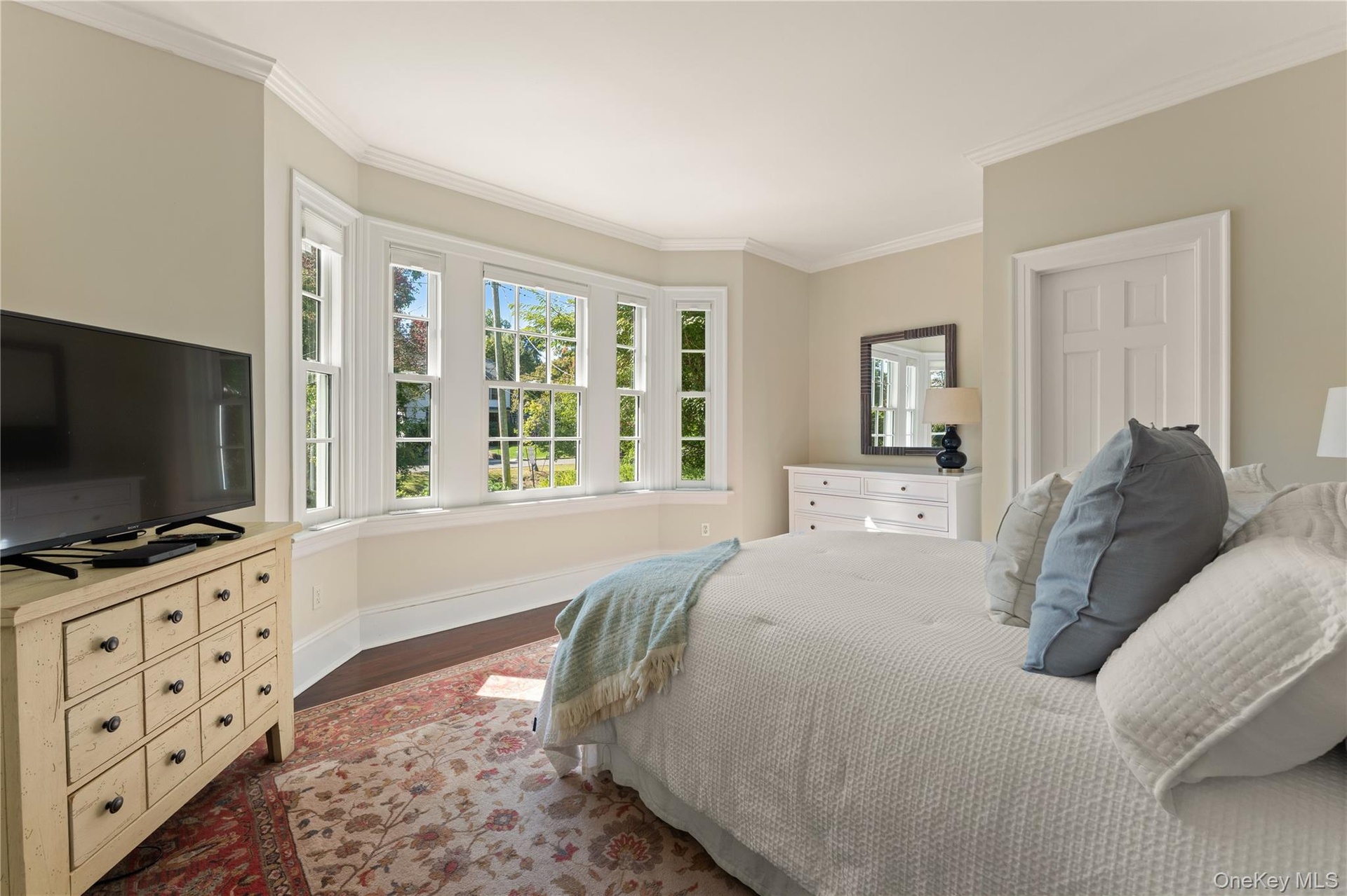 Generous first-floor ensuite bedroom with full bath offers flexibility for guests