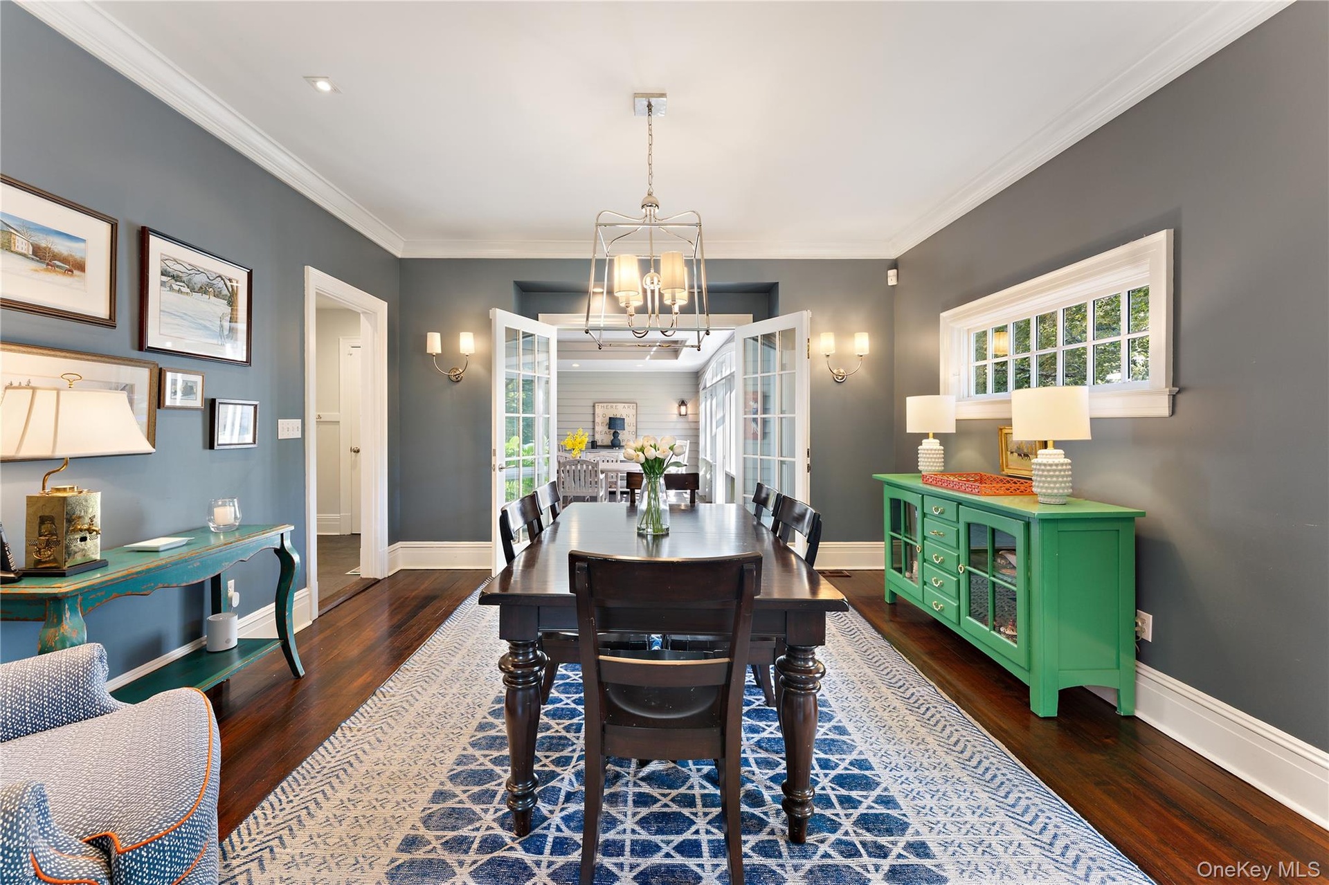 Spacious dining room with french doors leading to the window-lined porch/breezeway for easy entertaining