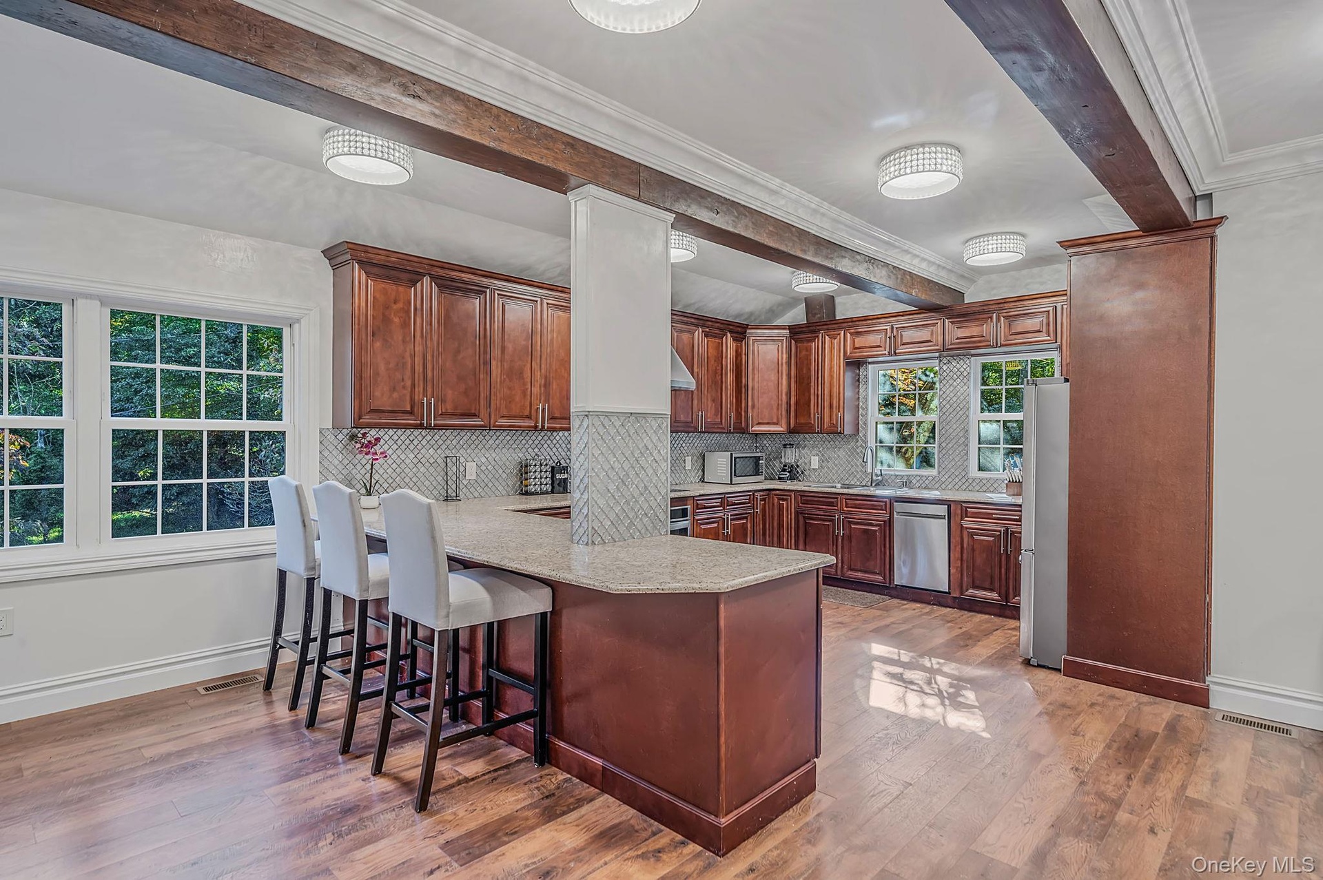Updated Kitchen with custom wood cabintrym breakfast bar and dining area