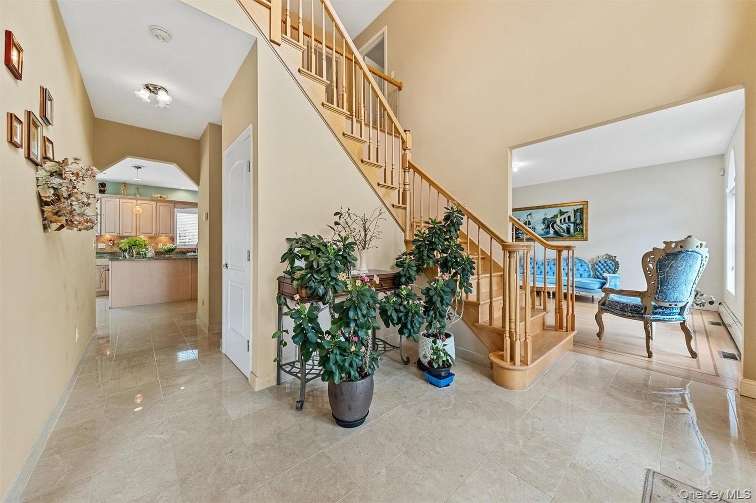 Stairway featuring arched walkways and a high ceiling