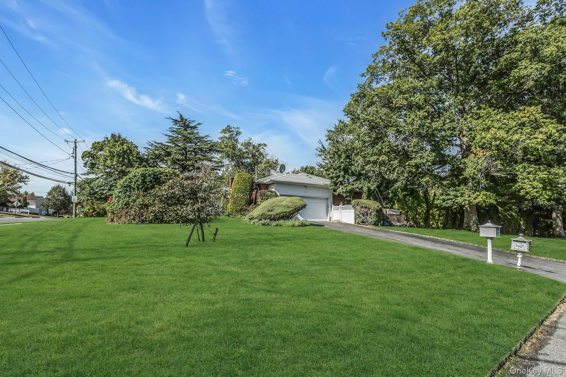 View of front of house with a front lawn and driveway