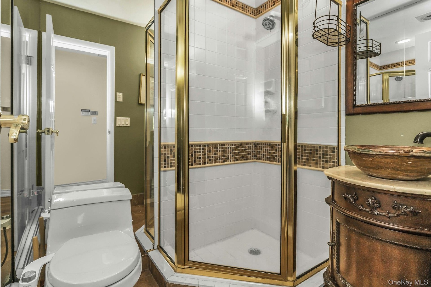 Bathroom with a shower stall and vanity