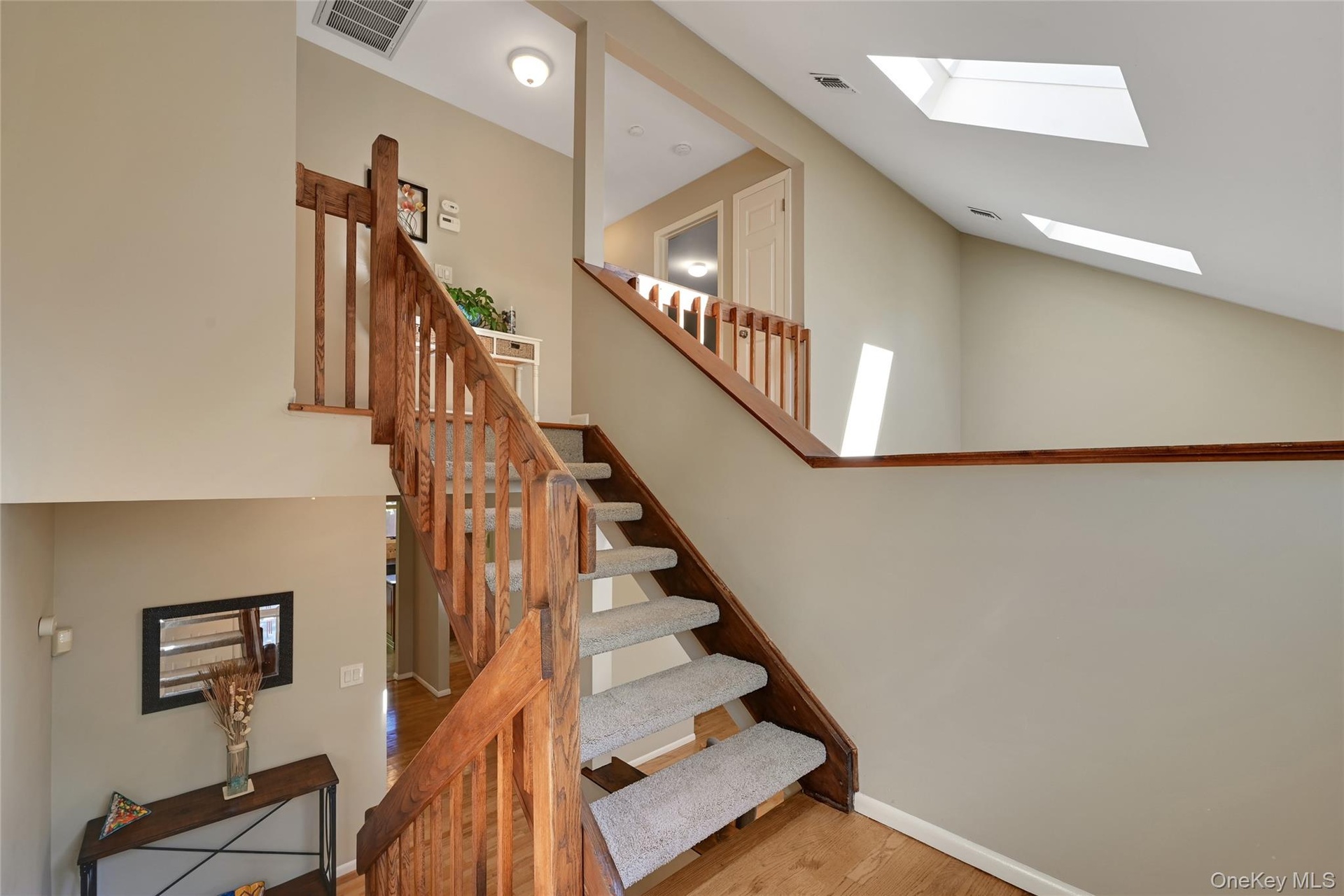 New carpeted staircase, and wood-finish flooring