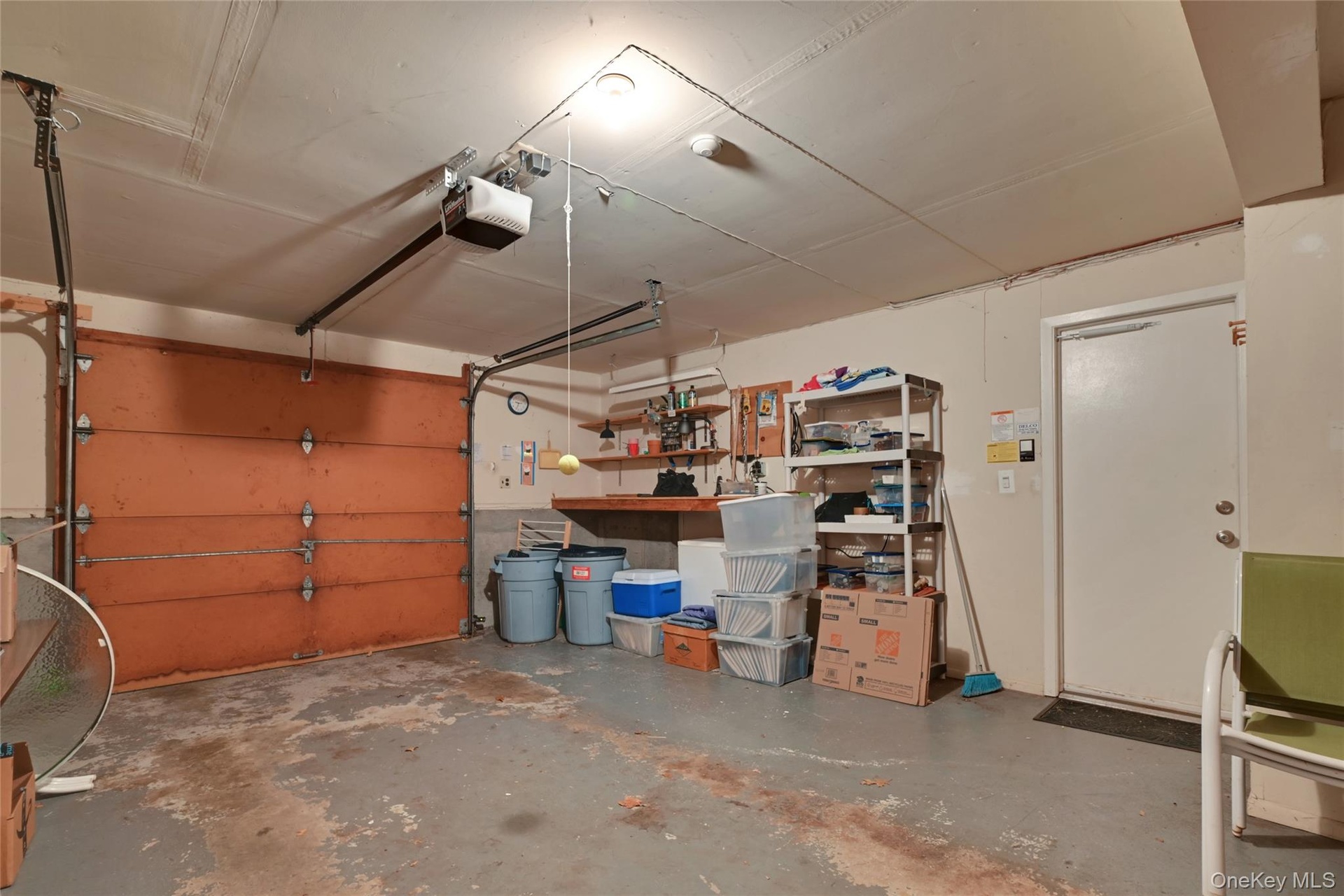 Single-vehicle garage with a sectional garage door and an automatic opener