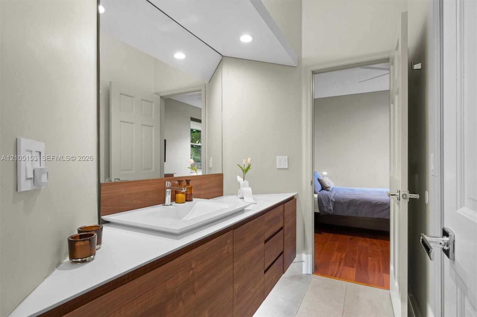 Floating wood-finish vanity with an integrated rectangular sink