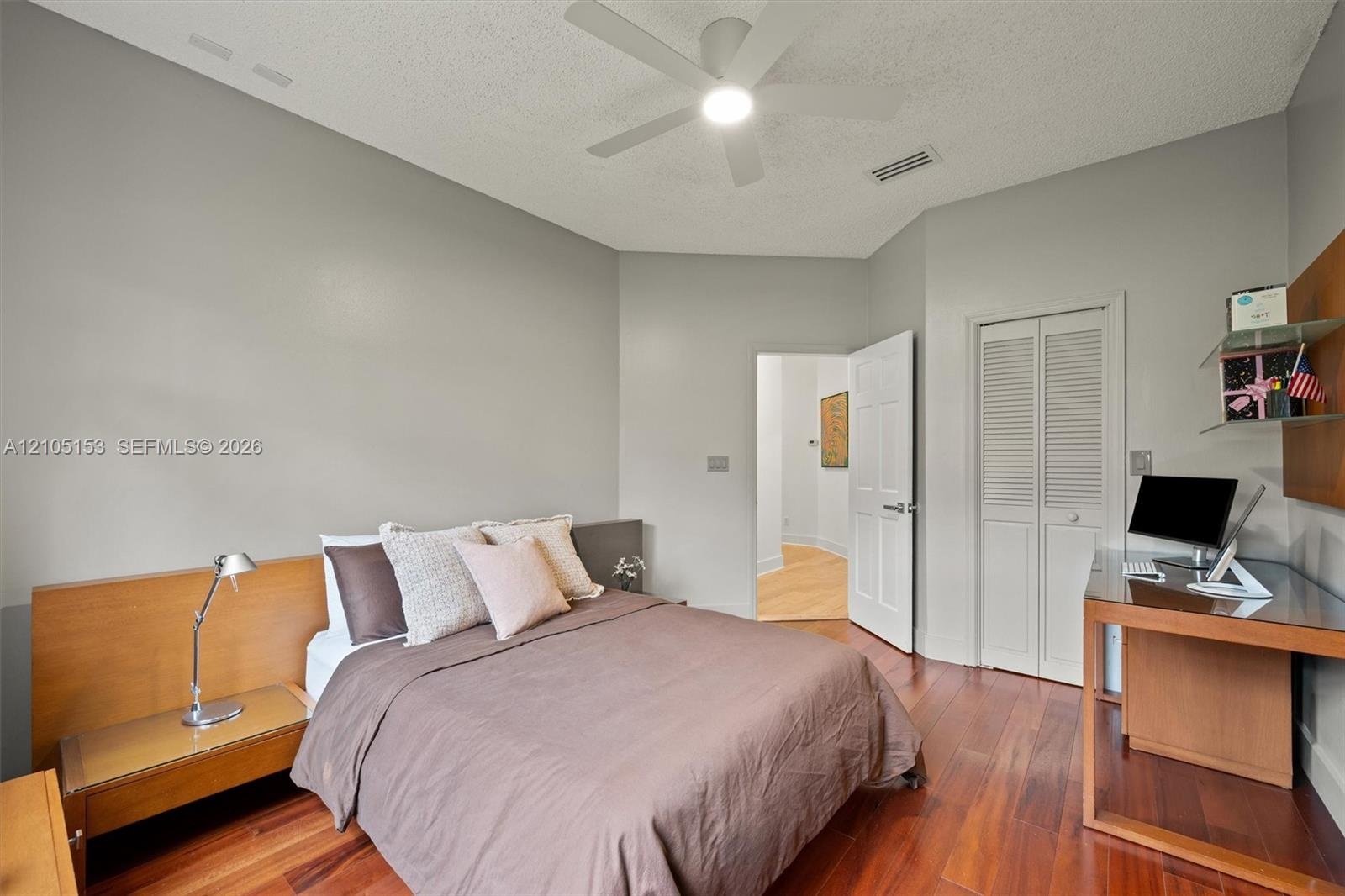 Hardwood-finish flooring, built-in shelving, folding louvered closet doors, and recessed lighting