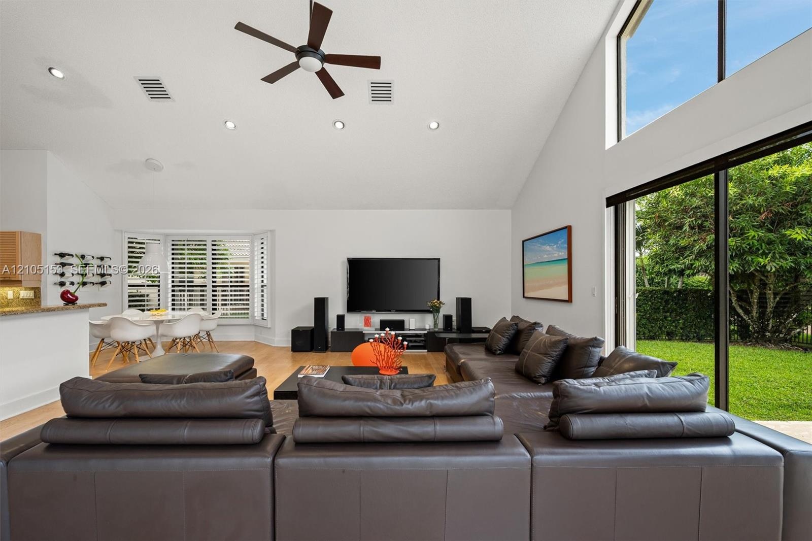 Vaulted ceiling with recessed lighting and ceiling fan