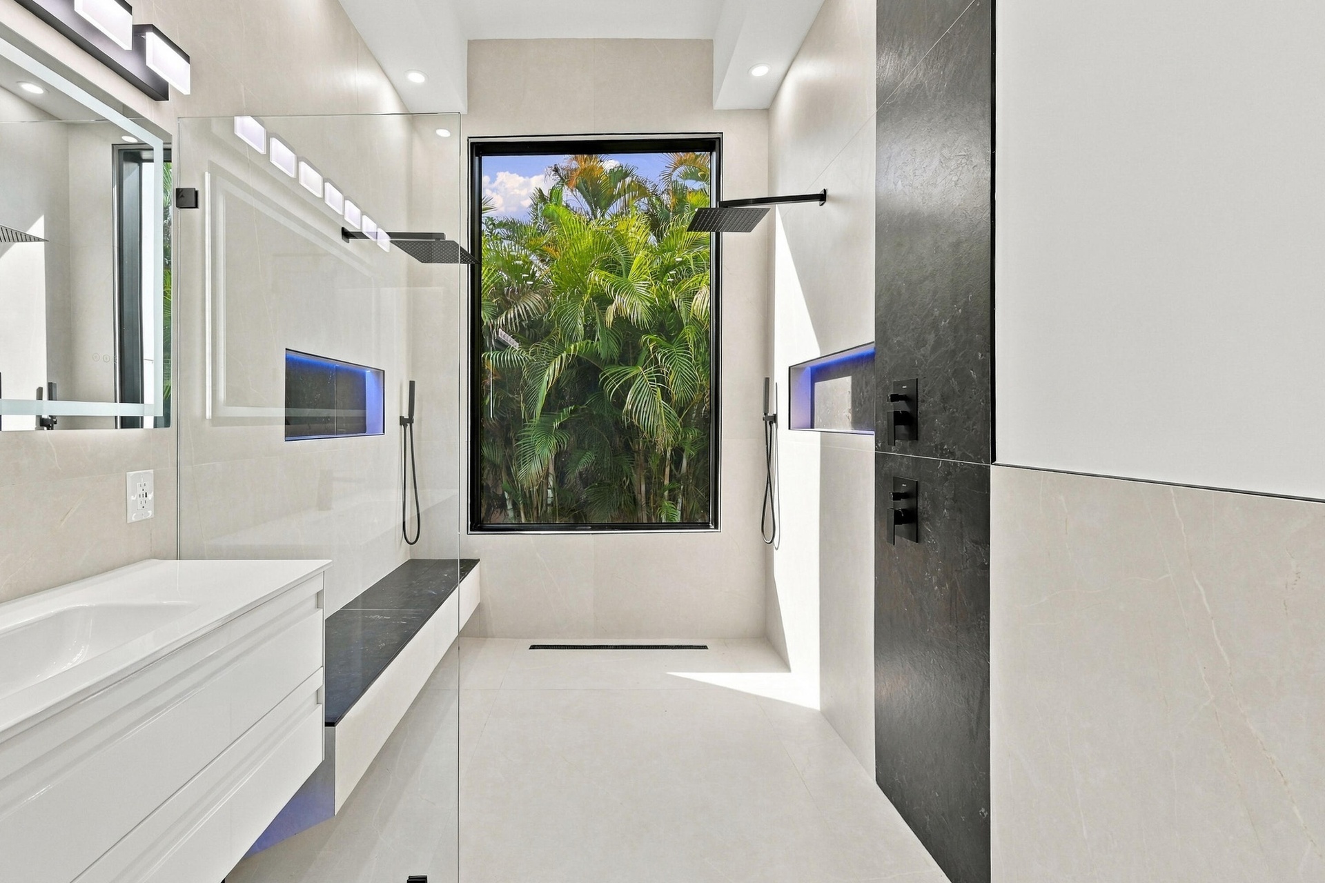Modern primary bathroom featuring a floating vanity with rectangular vessel sink, quartz countertop, and matte black wall-mounted faucet
