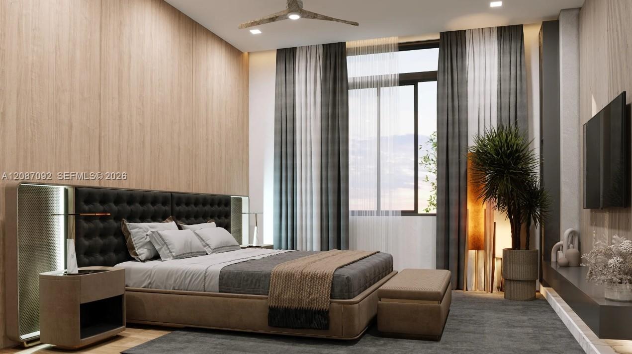 Wood-finish accent wall with integrated sconce lighting, recessed ceiling lighting, a contemporary ceiling fan, and a large window with privacy sheers