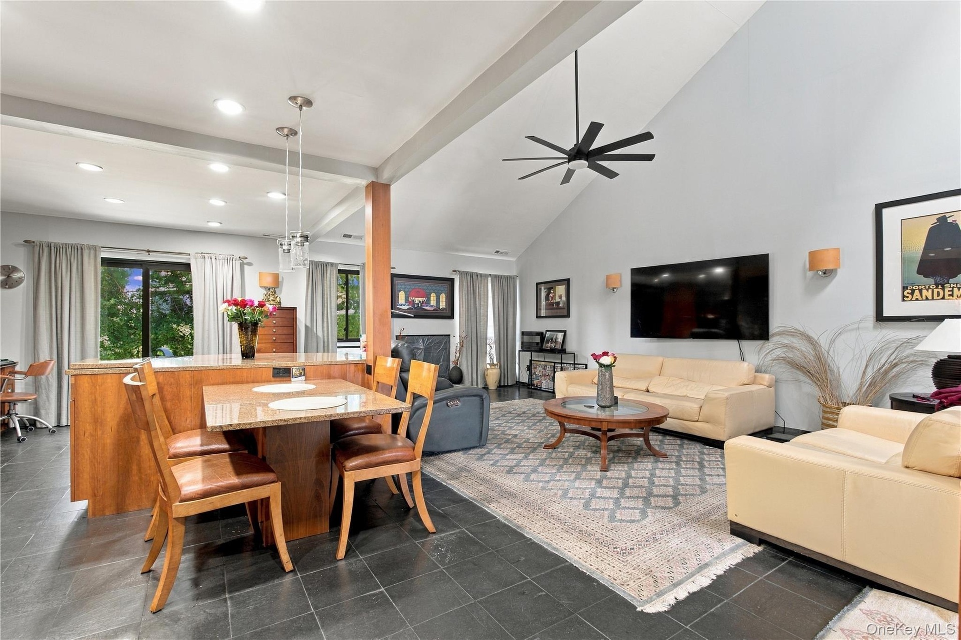 Vaulted ceiling with exposed beam and modern ceiling fan