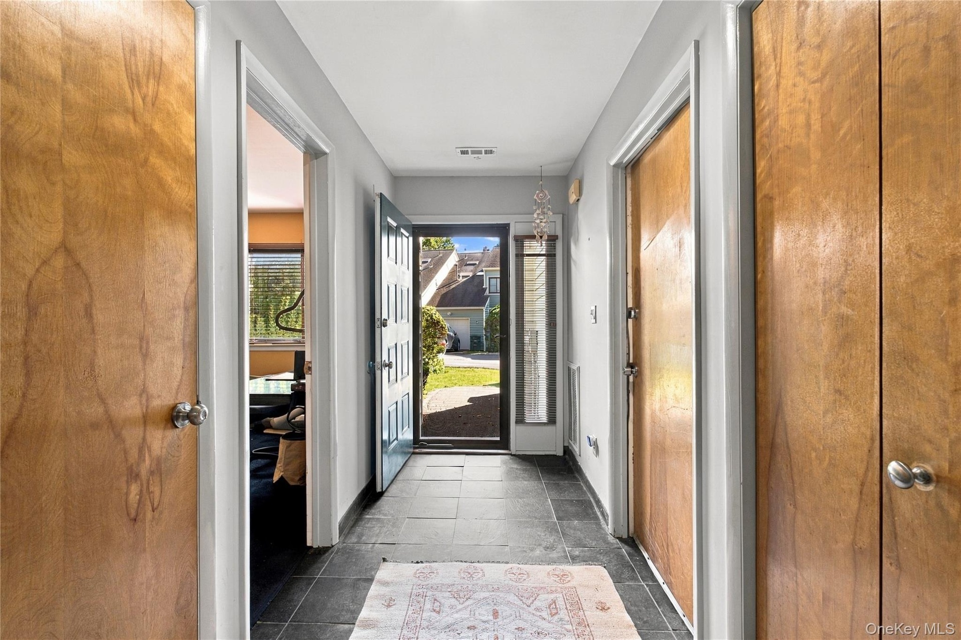 Entryway w/office on left and garage door to the right, closet and storage
