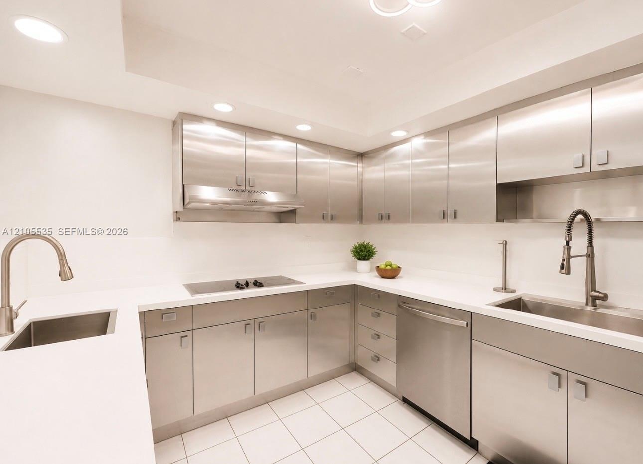 Modern kitchen featuring stainless steel cabinetry, white countertops, recessed lighting, and integrated stainless steel appliances