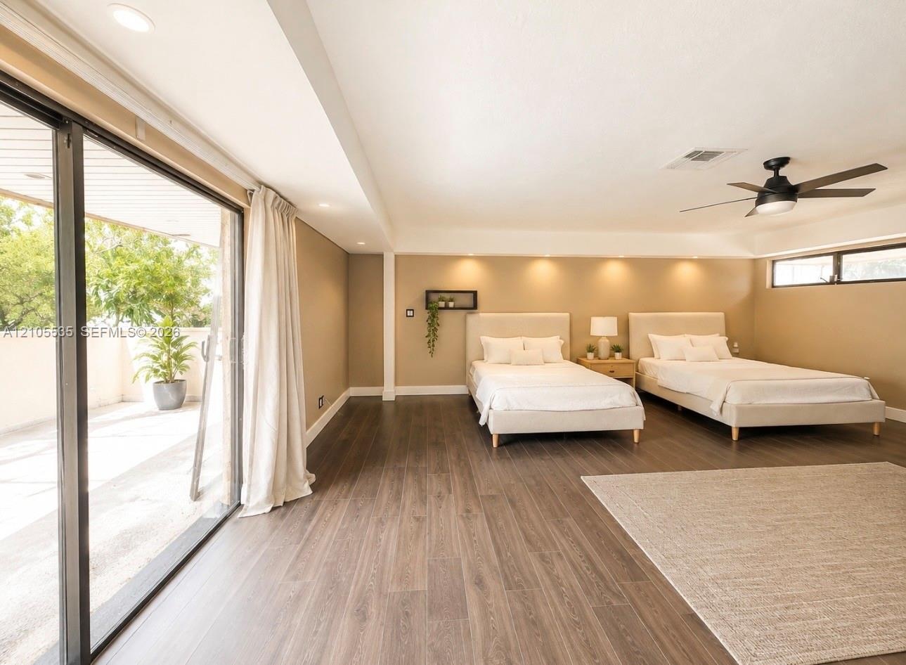 Wood-finish flooring, recessed lighting, and a black ceiling fan