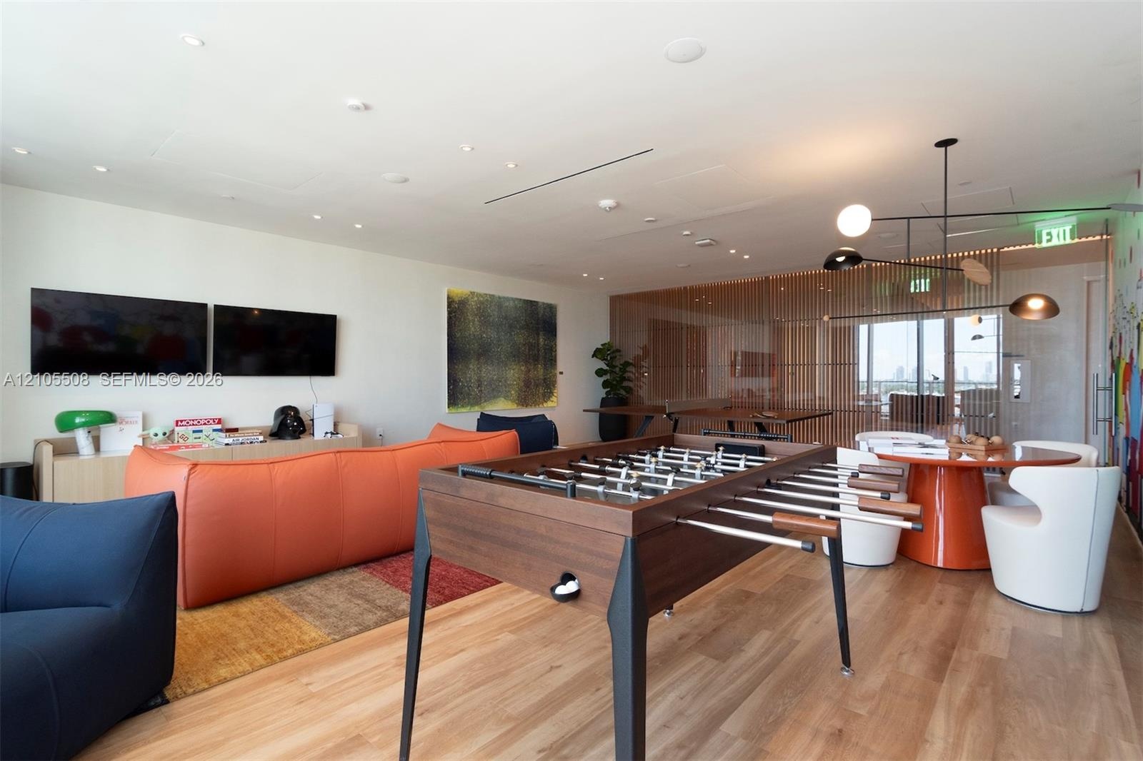 Recessed ceiling lighting, wood-finish flooring, and a decorative slatted wood partition