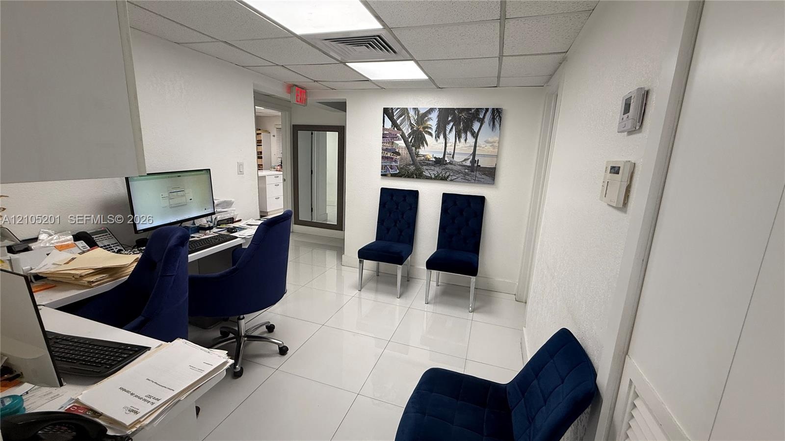 White tile flooring and white painted walls with recessed lighting