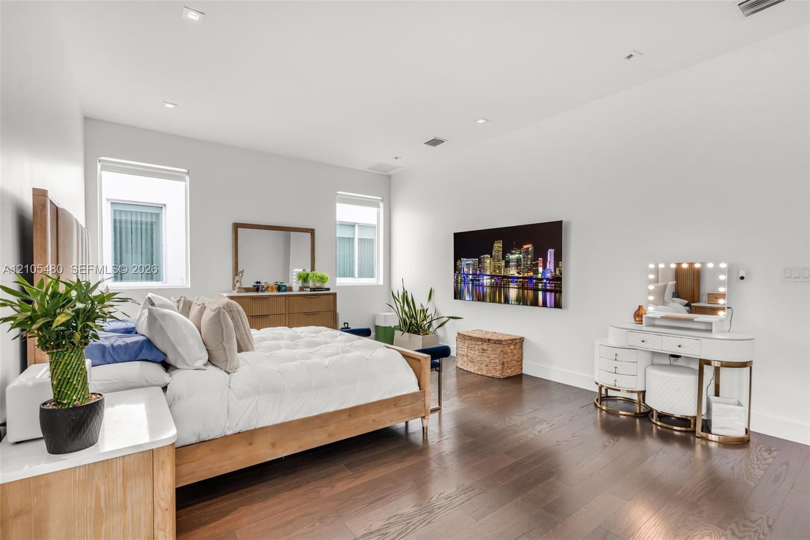Recessed lighting, wood-finish flooring, two windows, and white walls