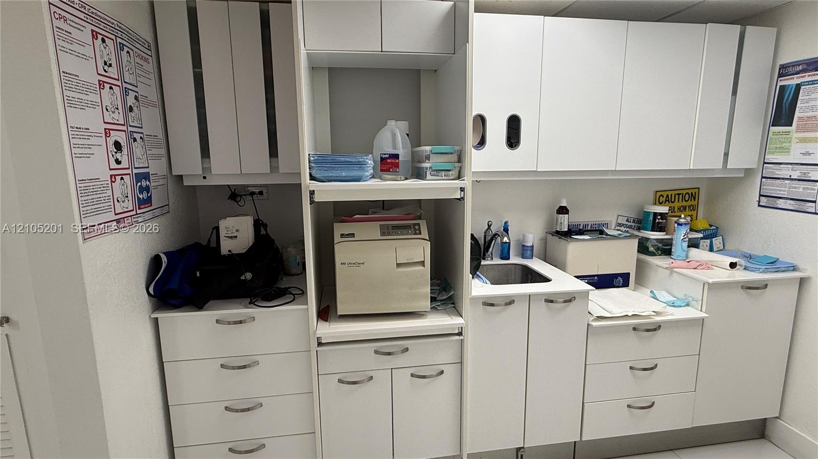 Extensive built-in white cabinetry, integrated sink, and white countertops