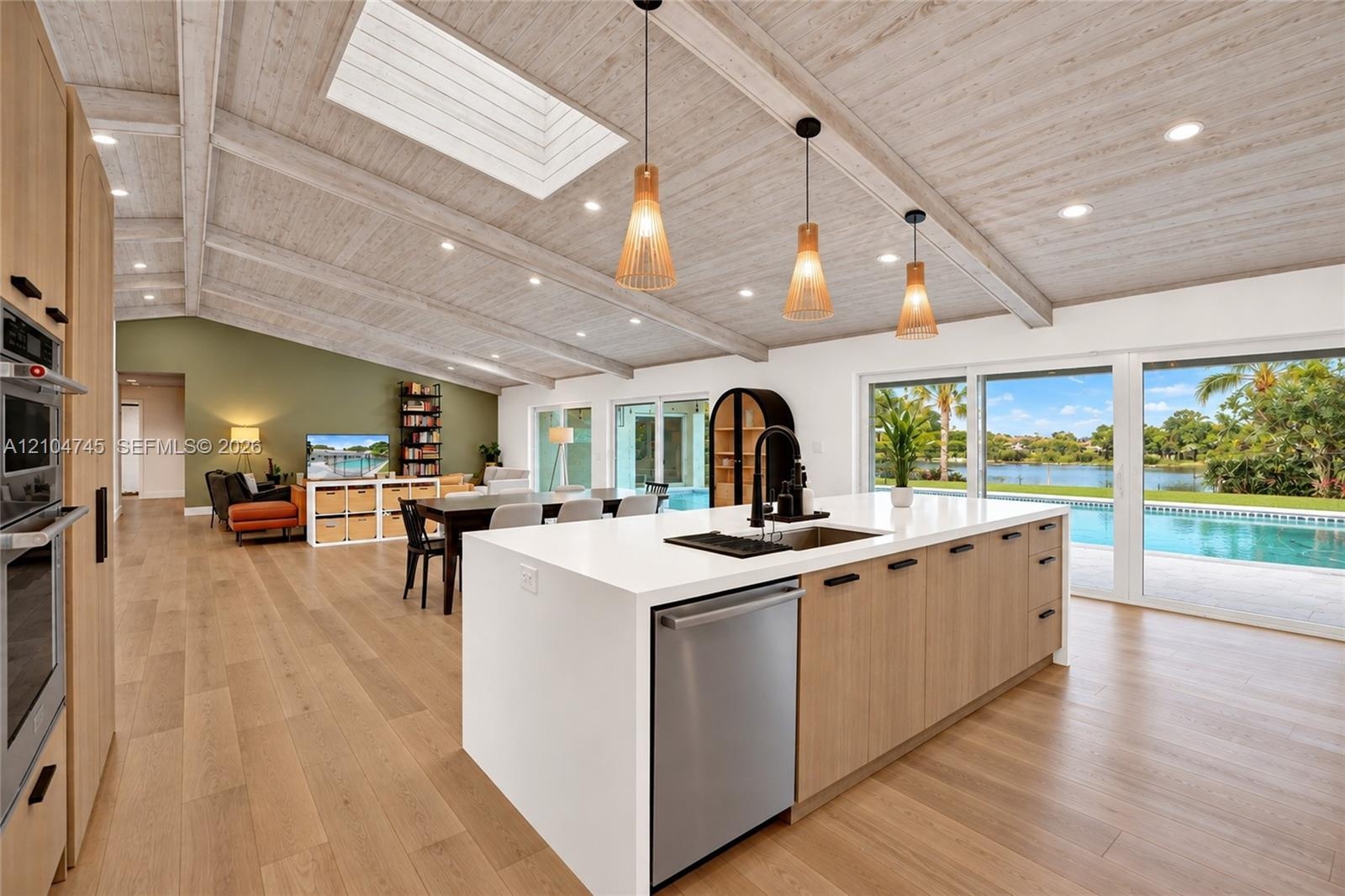 Vaulted wood-finish ceiling with exposed beams and skylight